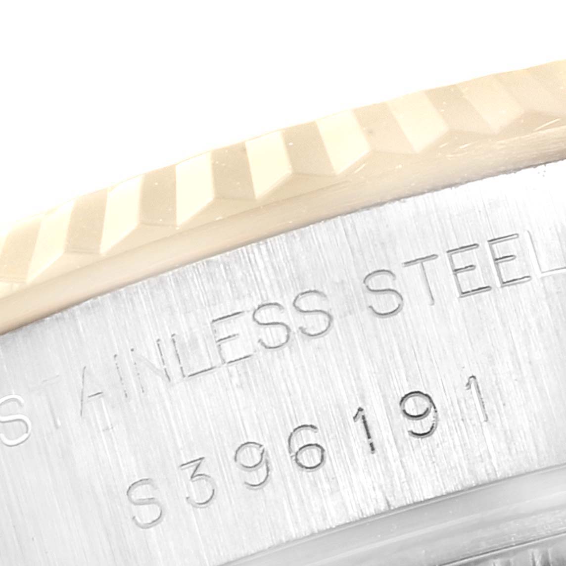 This close-up shows the inscription and fluted bezel of the Rolex Datejust 69173 Women's Steel and Gold (two tone) Champagne Dial 69173 Women's Steel and Gold (two tone) Champagne Dial model in stainless steel.