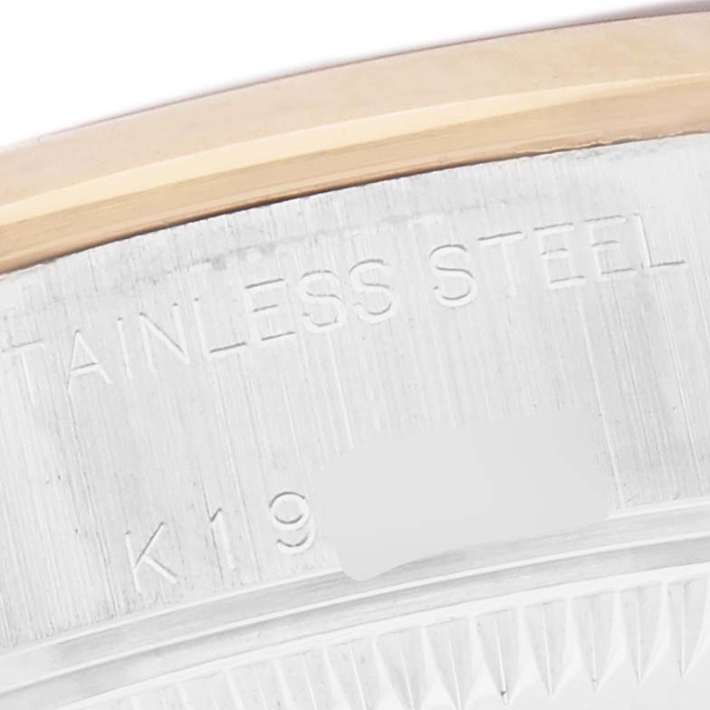 The image shows a close-up of the stainless steel case edge of a Rolex Datejust 79163 Women
s Steel and Gold (two tone) Mother of Pearl Dial 79163 Women
s Steel and Gold (two tone) Mother of Pearl Dial, highlighting the material engraving.