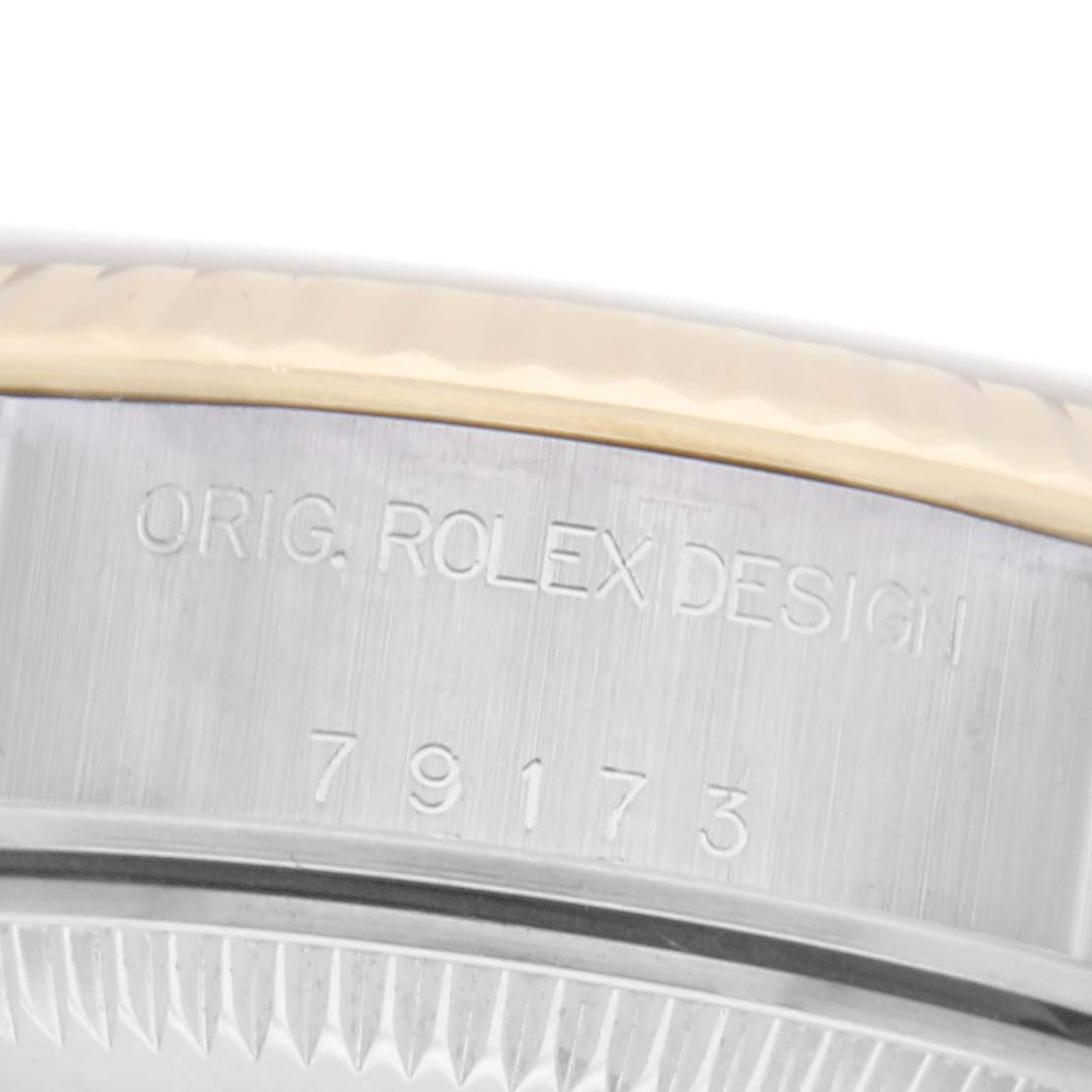 The image shows a close-up of the side of the Rolex Datejust 79173 Women
s Steel and Gold (two tone) Silver Dial 79173 Women
s Steel and Gold (two tone) Silver Dial, highlighting the "ORIG. ROLEX DESIGN" and model number engraving.