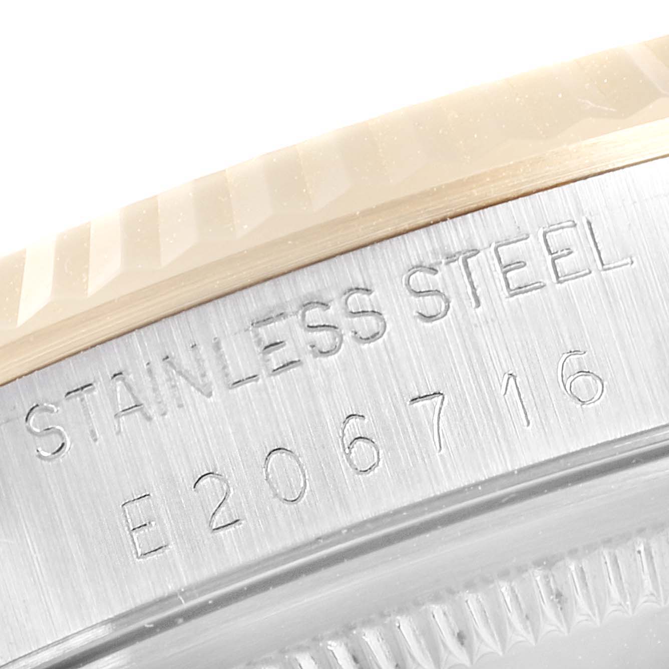 This close-up image of a Rolex Datejust 16233 Men's Steel and Gold (two tone) Grey Dial 16233 Men's Steel and Gold (two tone) Grey Dial watch shows the side of the stainless steel case with engraved text.