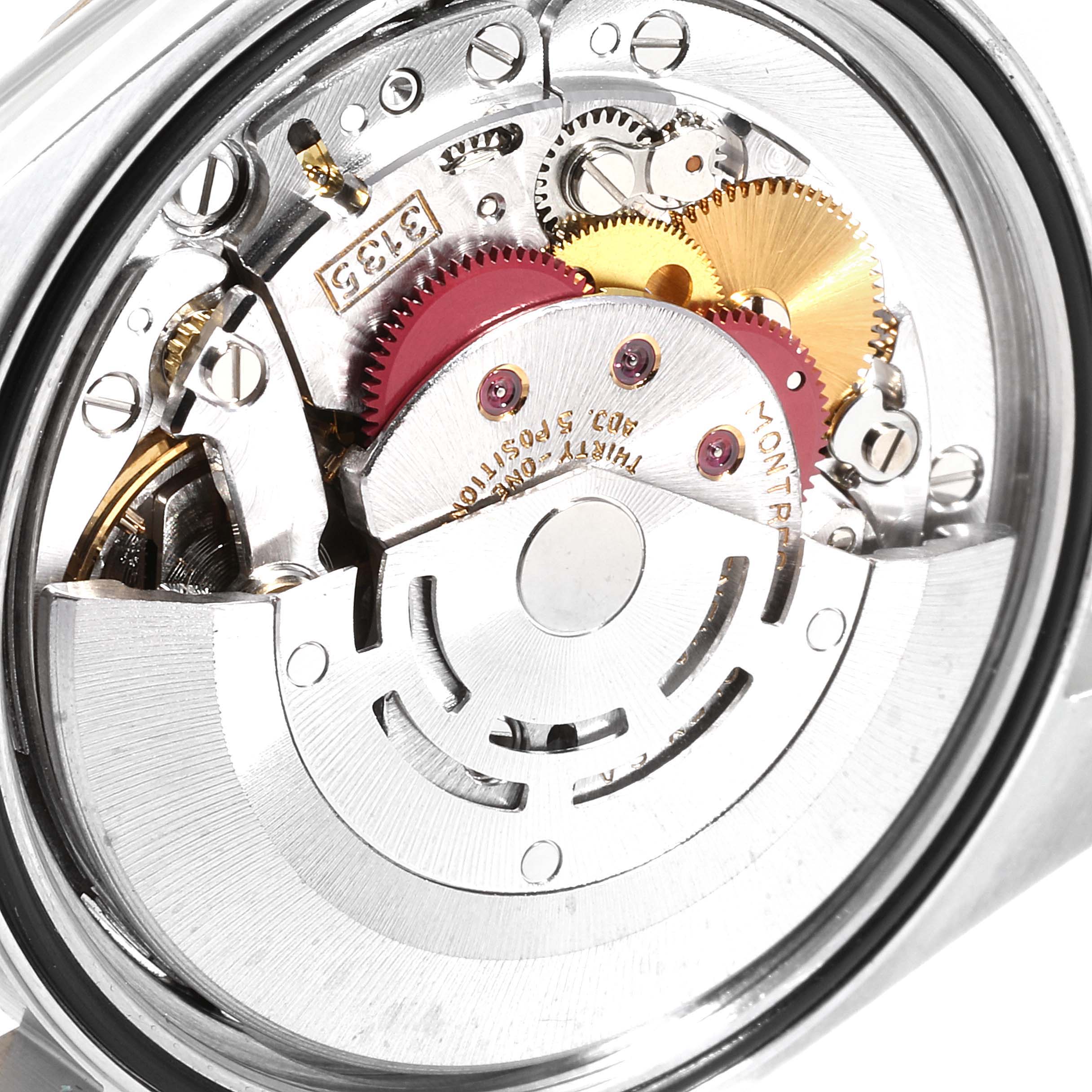 The image shows a close-up of the inner mechanical movement of a Rolex Datejust 16233 Men's Steel and Gold (two tone) Grey Dial 16233 Men's Steel and Gold (two tone) Grey Dial watch, highlighting gears and rotor.