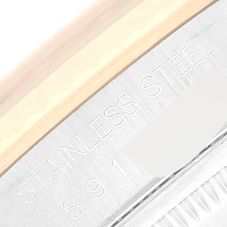 This close-up image shows the stainless steel section of a Rolex Datejust 16233 Men's Steel and Gold (two tone) Grey Dial 16233 Men's Steel and Gold (two tone) Grey Dial watch, specifically part of the rim and some engraved text.