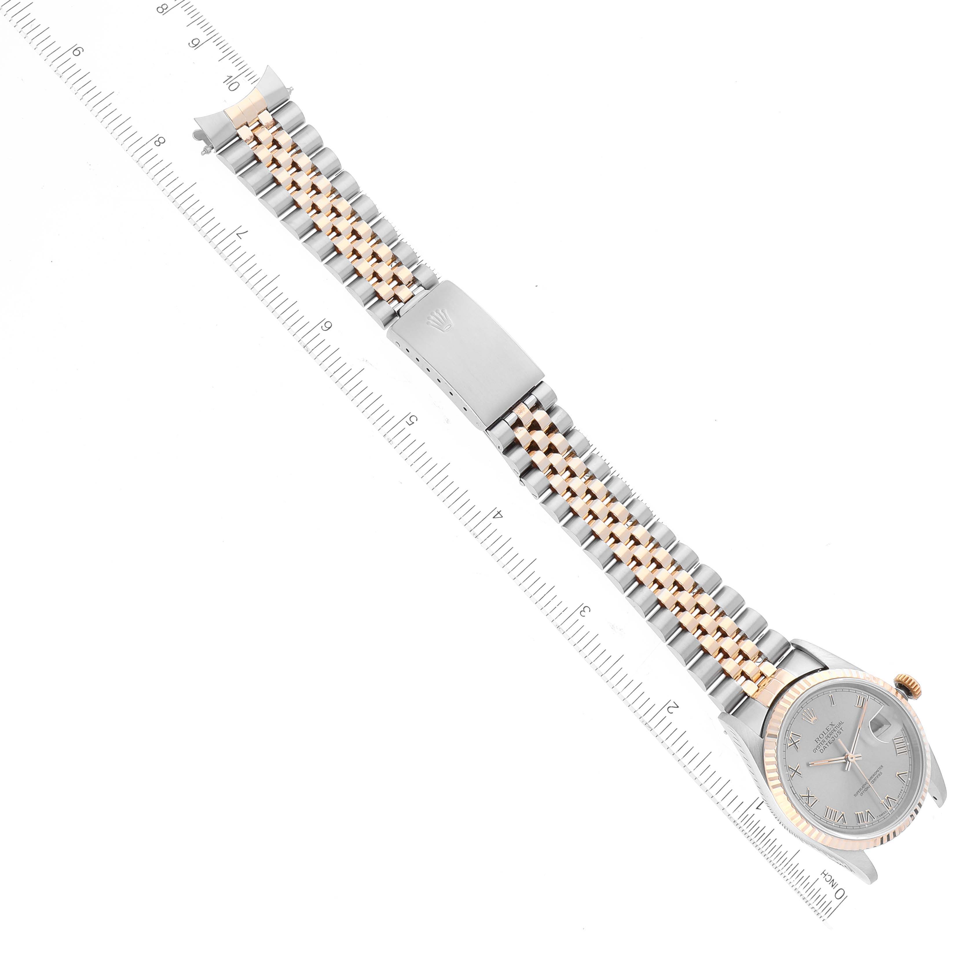 The image shows a top view of a Rolex Datejust 16233 Men's Steel and Gold (two tone) Grey Dial 16233 Men's Steel and Gold (two tone) Grey Dial watch, featuring its face, bracelet, and clasp with a ruler for scale.