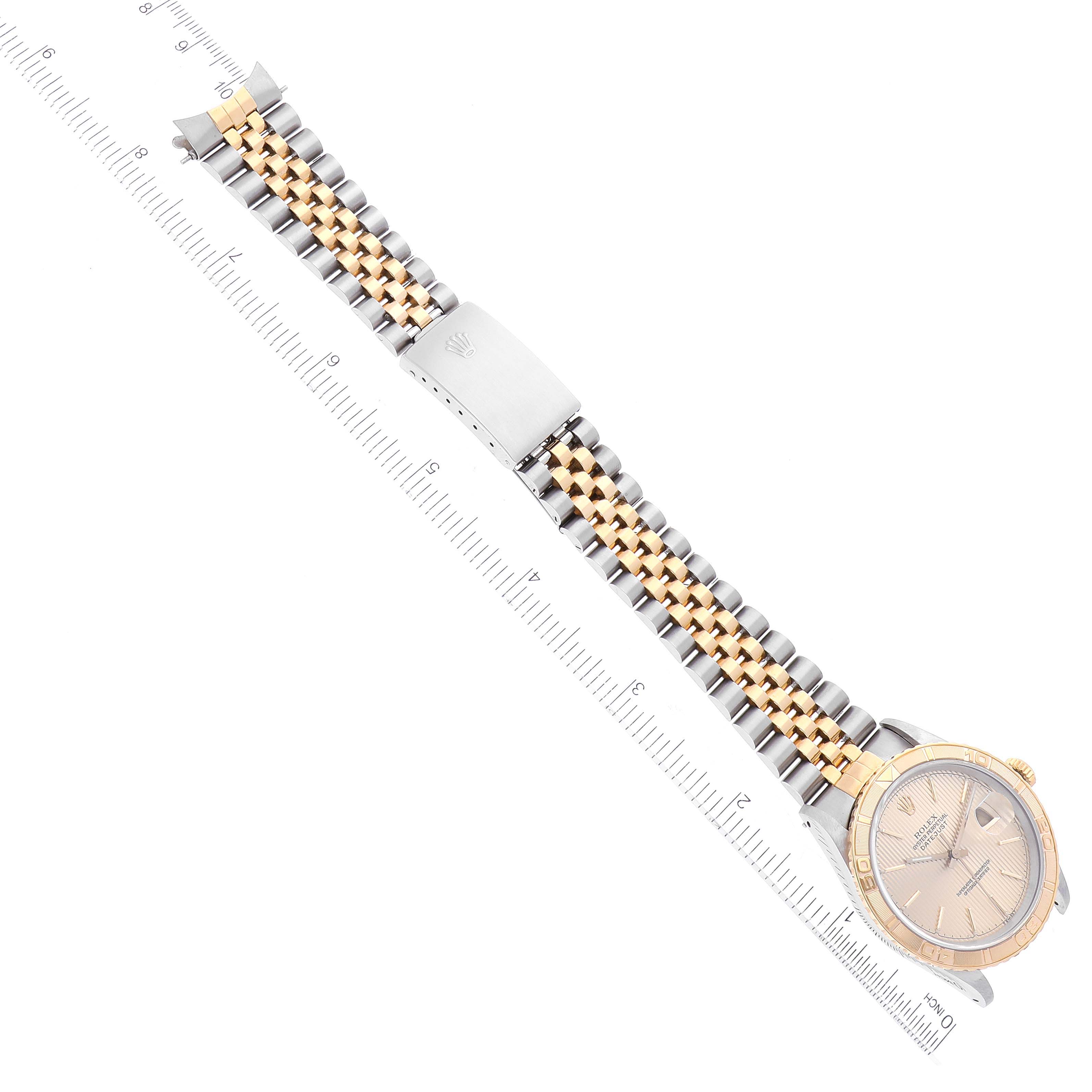 The image shows a top view of a Rolex Turn-o-Graph 16263 Men's Steel and Gold (two tone) Champagne Dial 16263 Men's Steel and Gold (two tone) Champagne Dial watch, highlighting the face and metal bracelet alongside a ruler for scale.