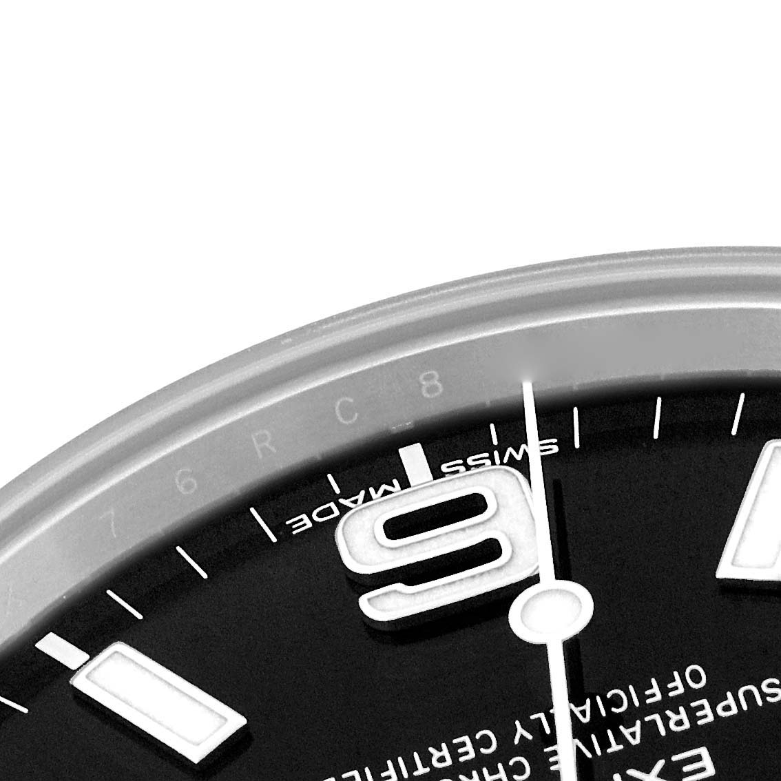 This close-up image shows part of the dial of a Rolex Explorer 214270 Men
s Stainless Steel Black Dial 214270 Men
s Stainless Steel Black Dial watch, including the numbers 6 and 9, and the minute markers.