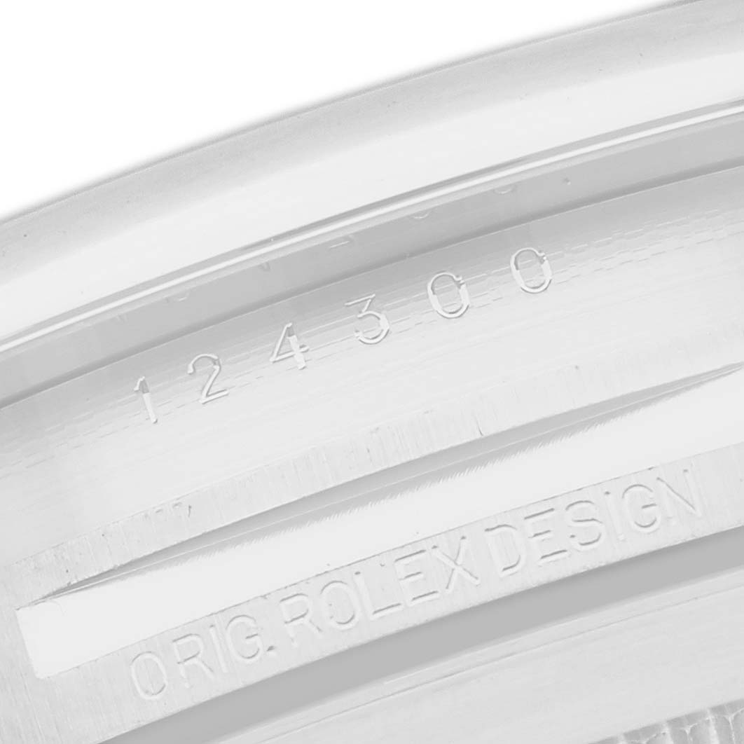 The image shows a close-up of the engraved casing edge of a Rolex Oyster Perpetual 124300 Men
s Stainless Steel Silver Dial 124300 Men
s Stainless Steel Silver Dial, highlighting the model number.