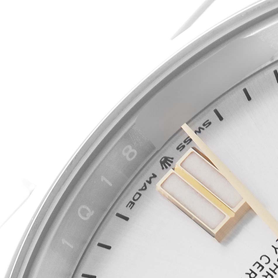 The image shows a close-up of the dial and markers of a Rolex Oyster Perpetual 124300 Men
s Stainless Steel Silver Dial 124300 Men
s Stainless Steel Silver Dial watch at an angled view.
