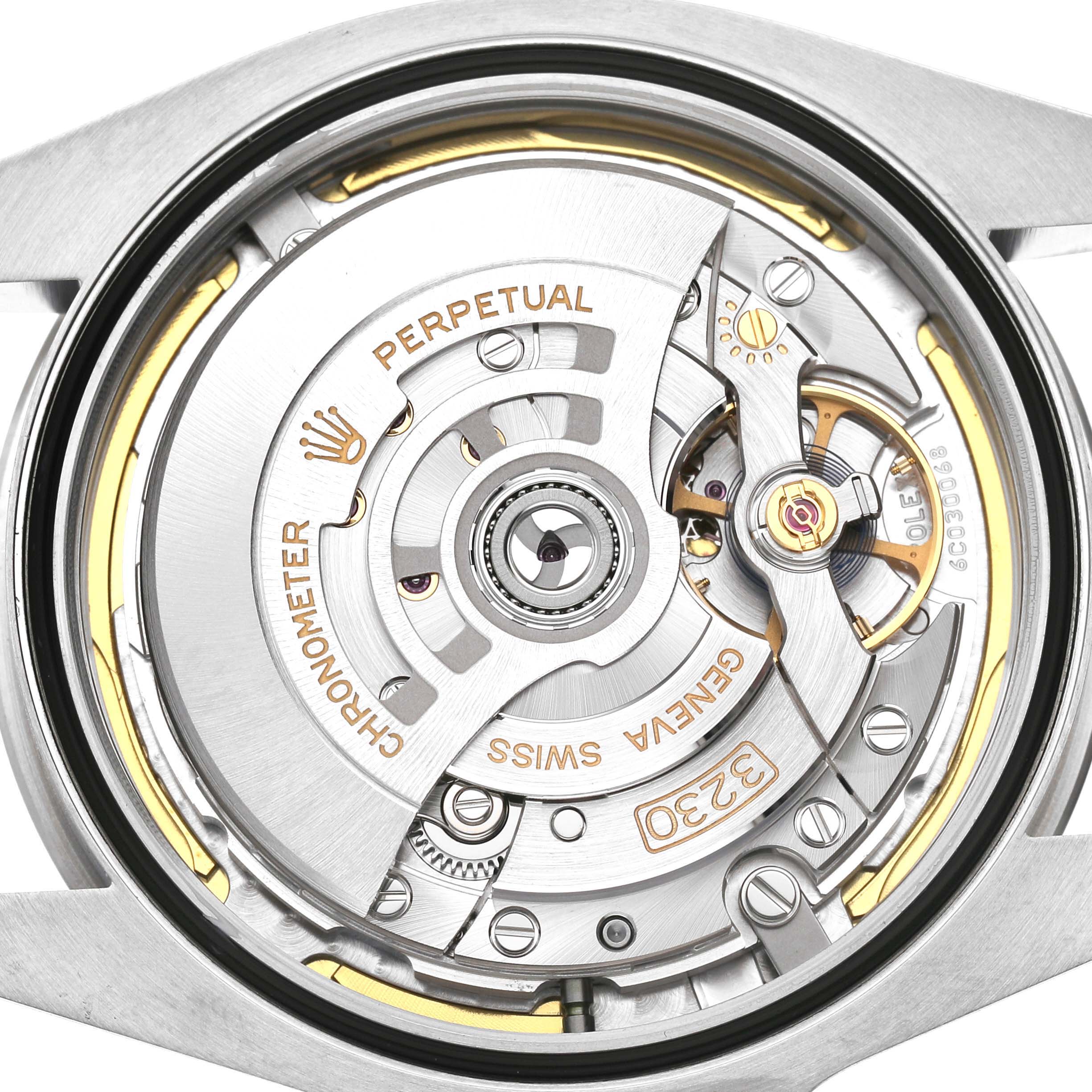 The image shows the movement of a Rolex Air-King M126900-0001 Men's Stainless Steel Black Dial watch from a top-down view, highlighting its intricate mechanical components.