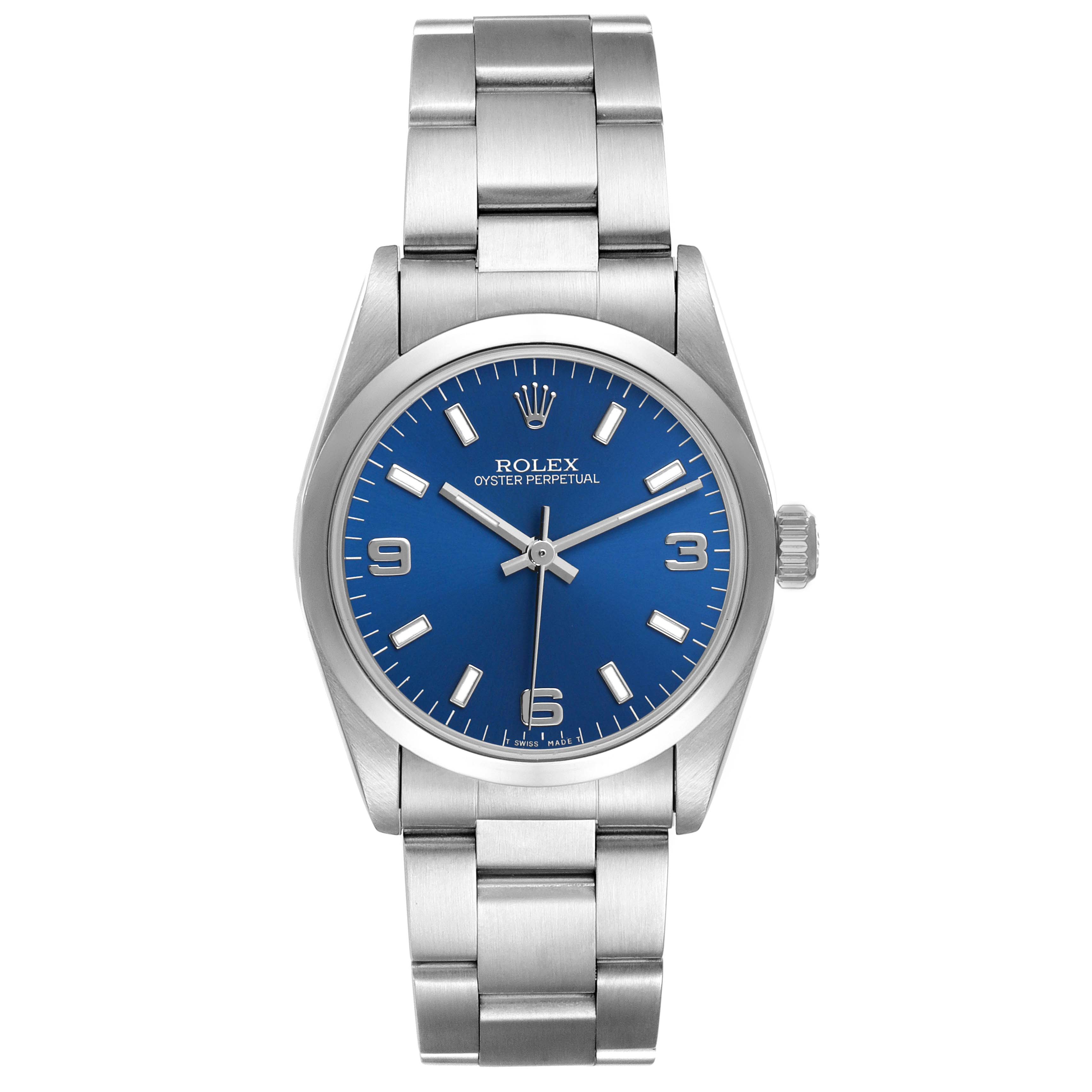 The Rolex Mid-Size 67480 Women's Stainless Steel Blue Dial watch is shown from the front, featuring its blue dial, silver bracelet, and crown.