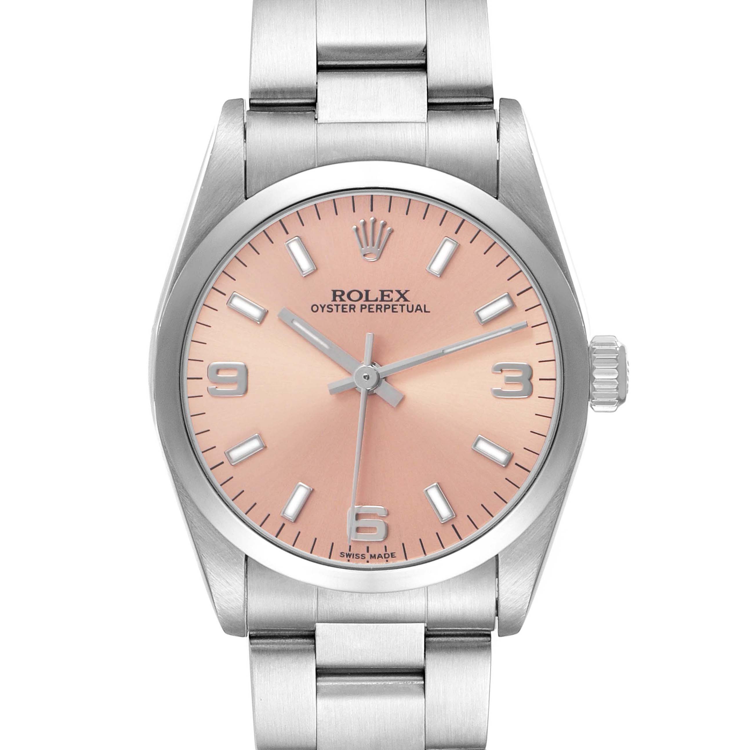 The Rolex Oyster Perpetual Mid-Size watch is shown from the front, displaying its pink dial, hour markers, crown, and stainless steel bracelet.