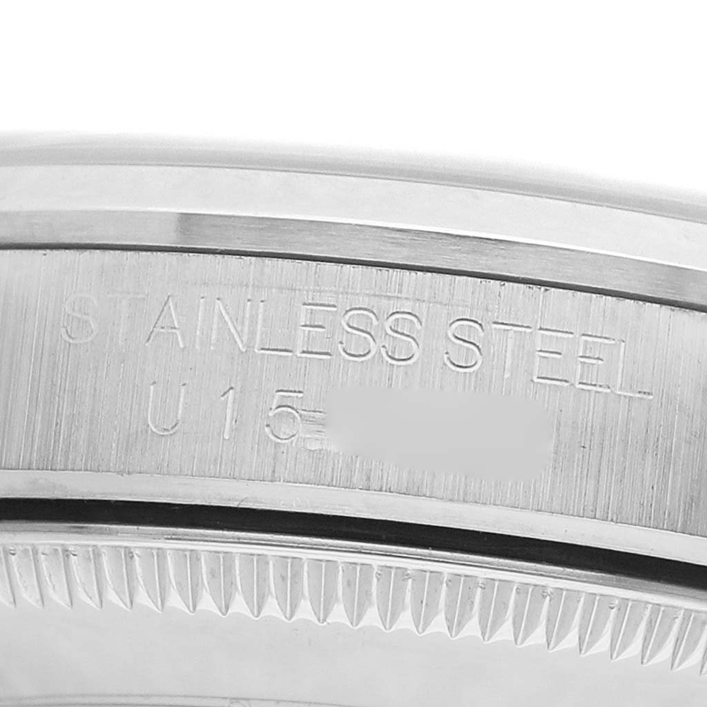 The image shows a close-up of the engraved stainless steel case back edge of a Rolex Mid-Size 67480 Women's Stainless Steel Pink Dial model.