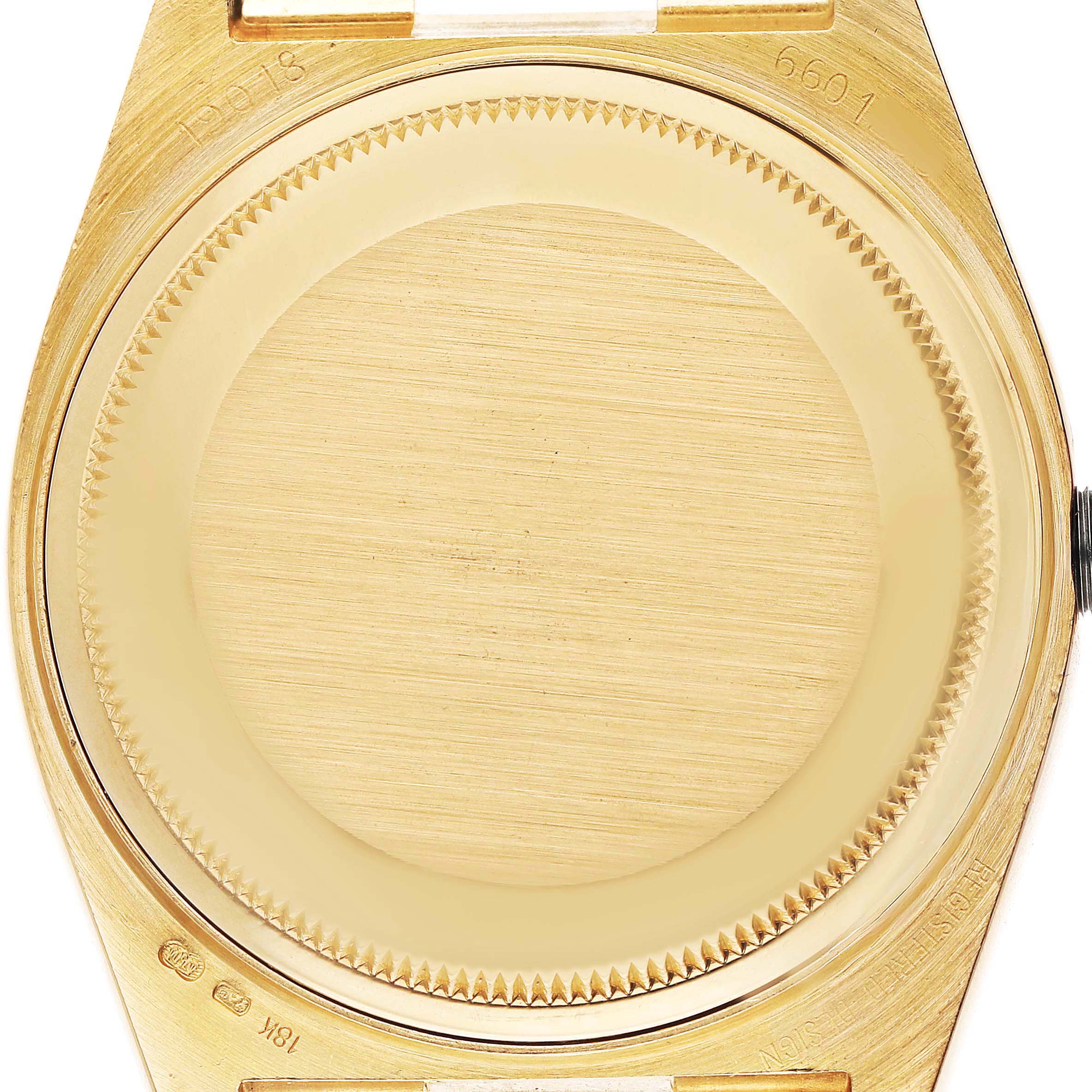 The image shows the case back and surrounding area of the Rolex President 82028 Men's Yellow Gold Champagne Dial watch from a top-down angle.
