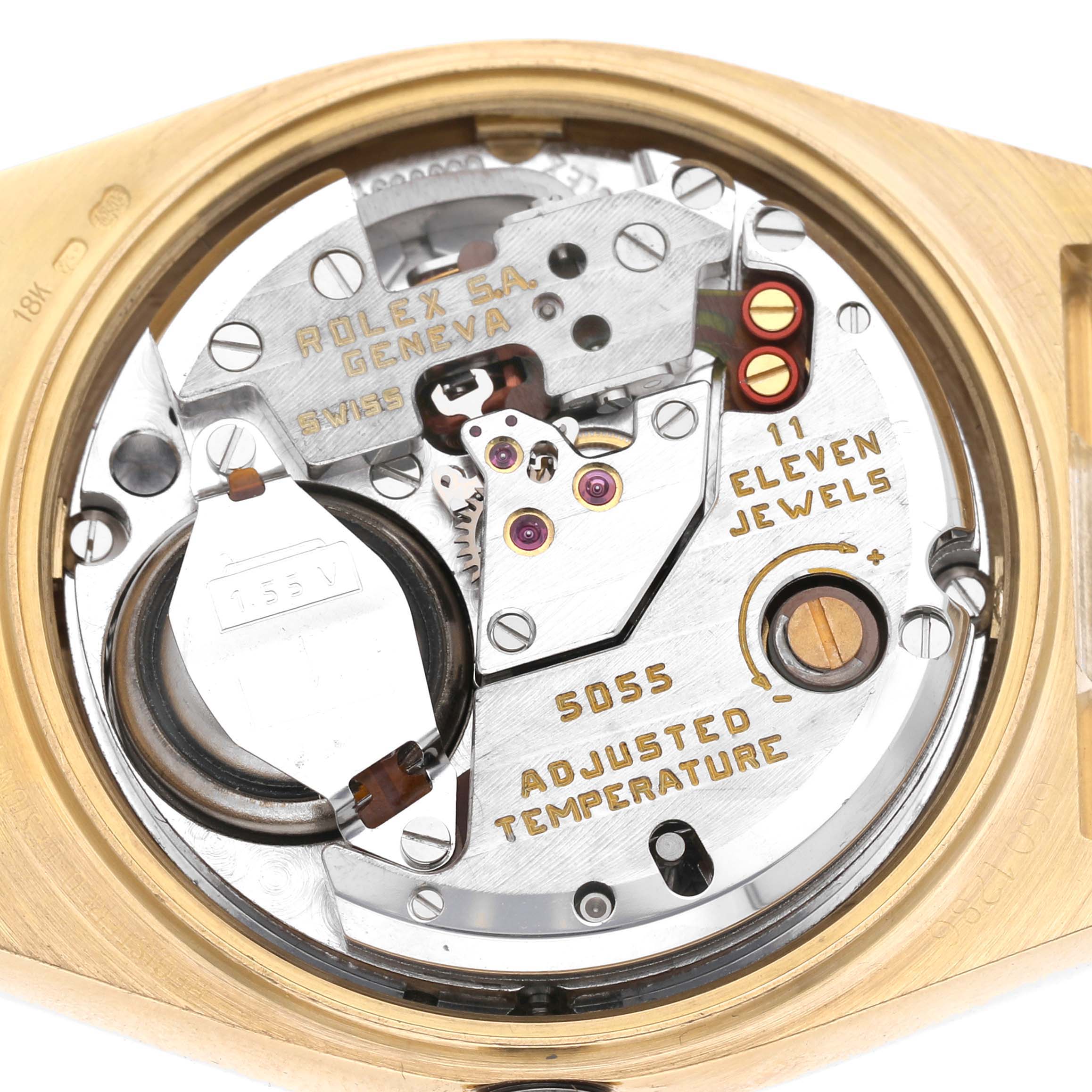 The image shows the movement of a Rolex President 82028 Men's Yellow Gold Champagne Dial model from the back, highlighting its mechanical components and inscriptions.