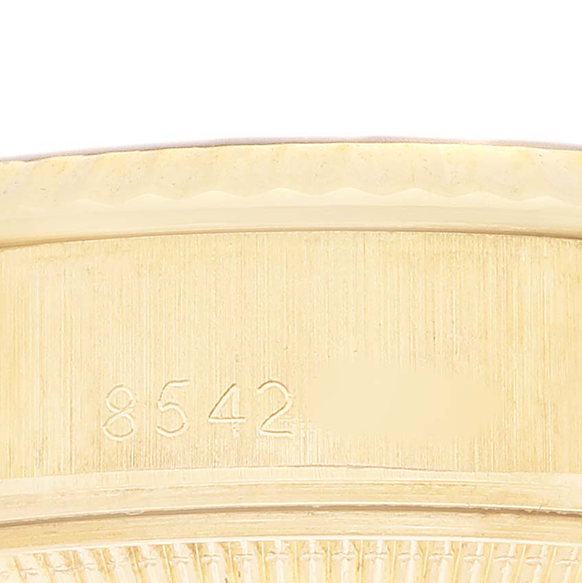 The image shows the side of a Rolex President 69178 Women's Yellow Gold Black Dial watch band, displaying engraved numbers.