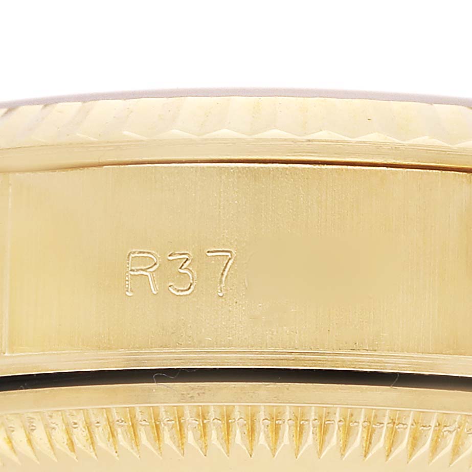 The image shows a close-up side view of the case and bezel of a Rolex President 69178 Women's Yellow Gold Champagne Dial model, highlighting its engravings and fluted design.
