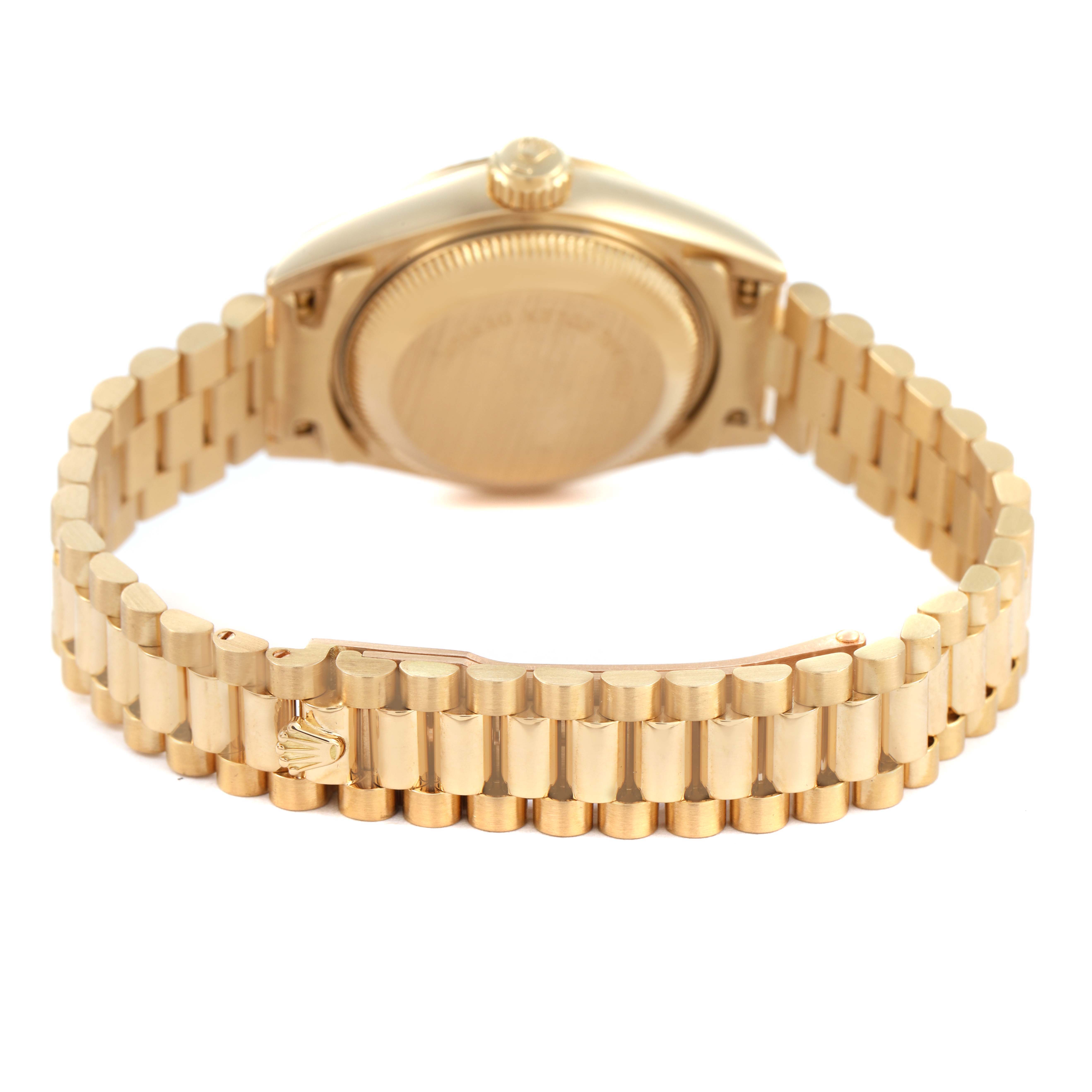 The image shows the back of a Rolex President 69178 Women's Yellow Gold Champagne Dial watch, highlighting the case back, bracelet, and clasp with the Rolex logo.