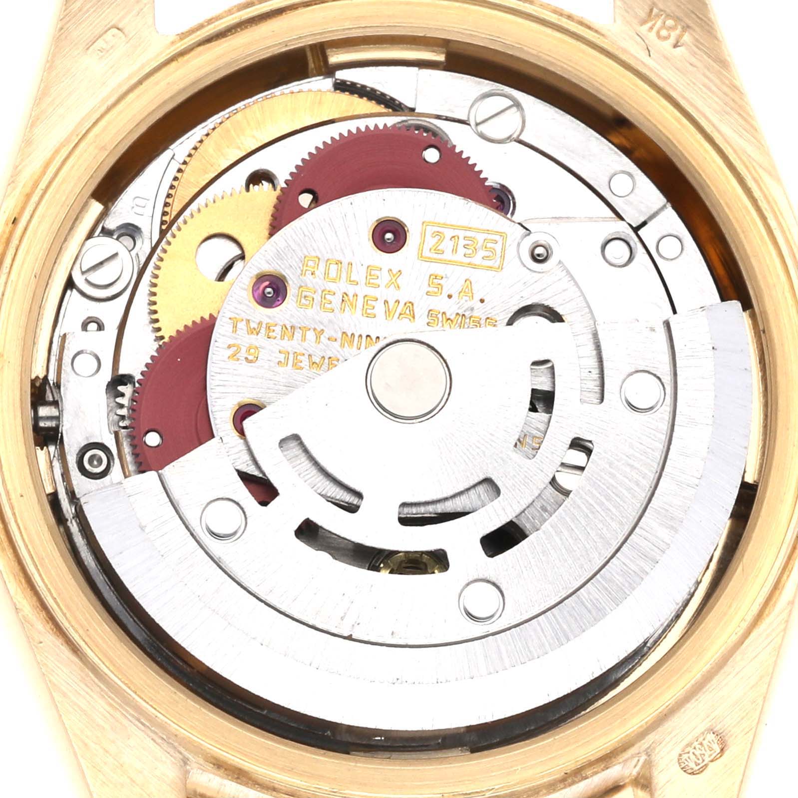 This image shows the internal movement and components of a Rolex President 69288G Women's Yellow Gold Black Dial 69288G Women's Yellow Gold Black Dial model, with an angled view highlighting gears and inscription details.