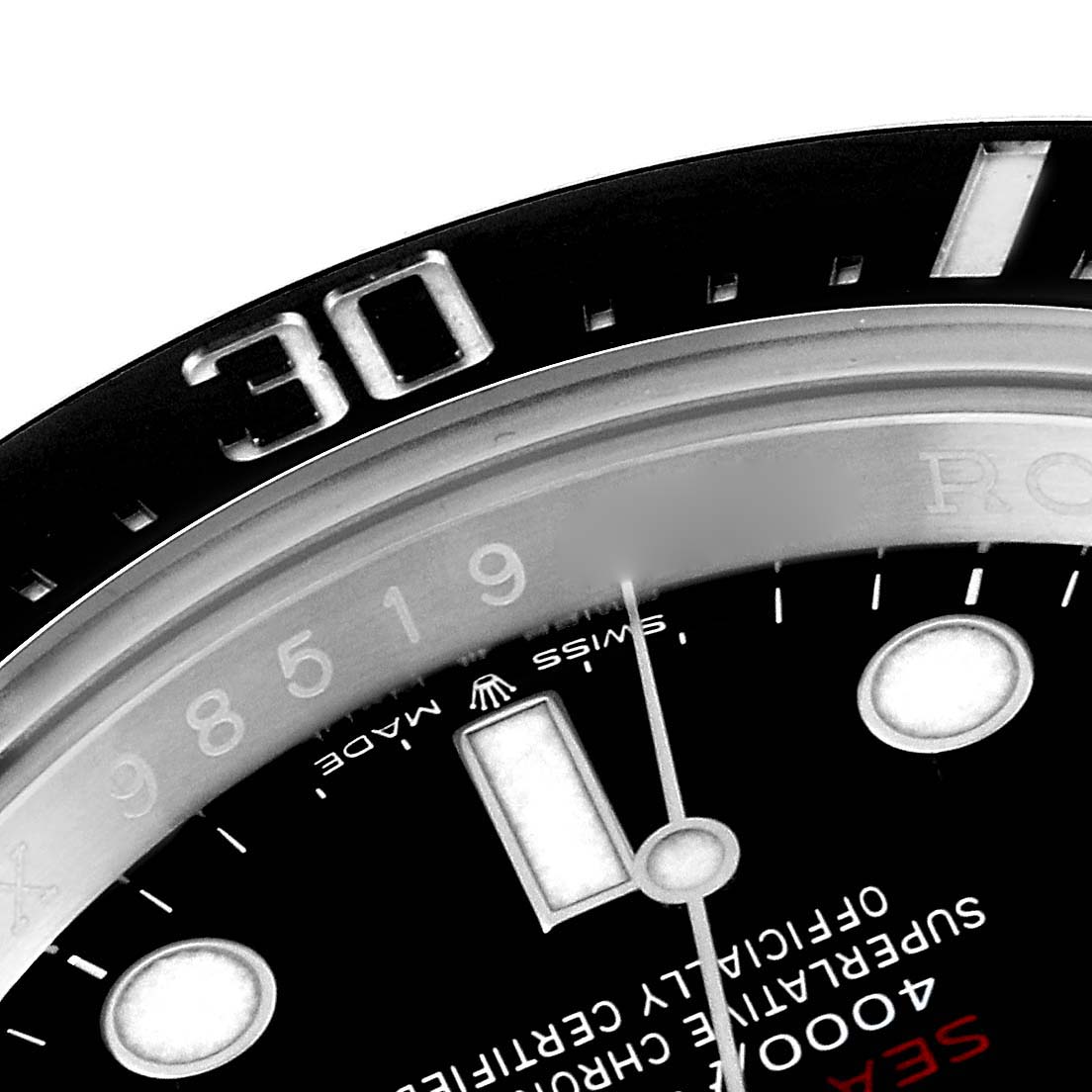 This image shows a close-up of the bezel and partial dial of the Rolex Sea-Dweller 126600 Men
s Stainless Steel Black Dial 126600 Men
s Stainless Steel Black Dial watch, highlighting the 30-minute marker.