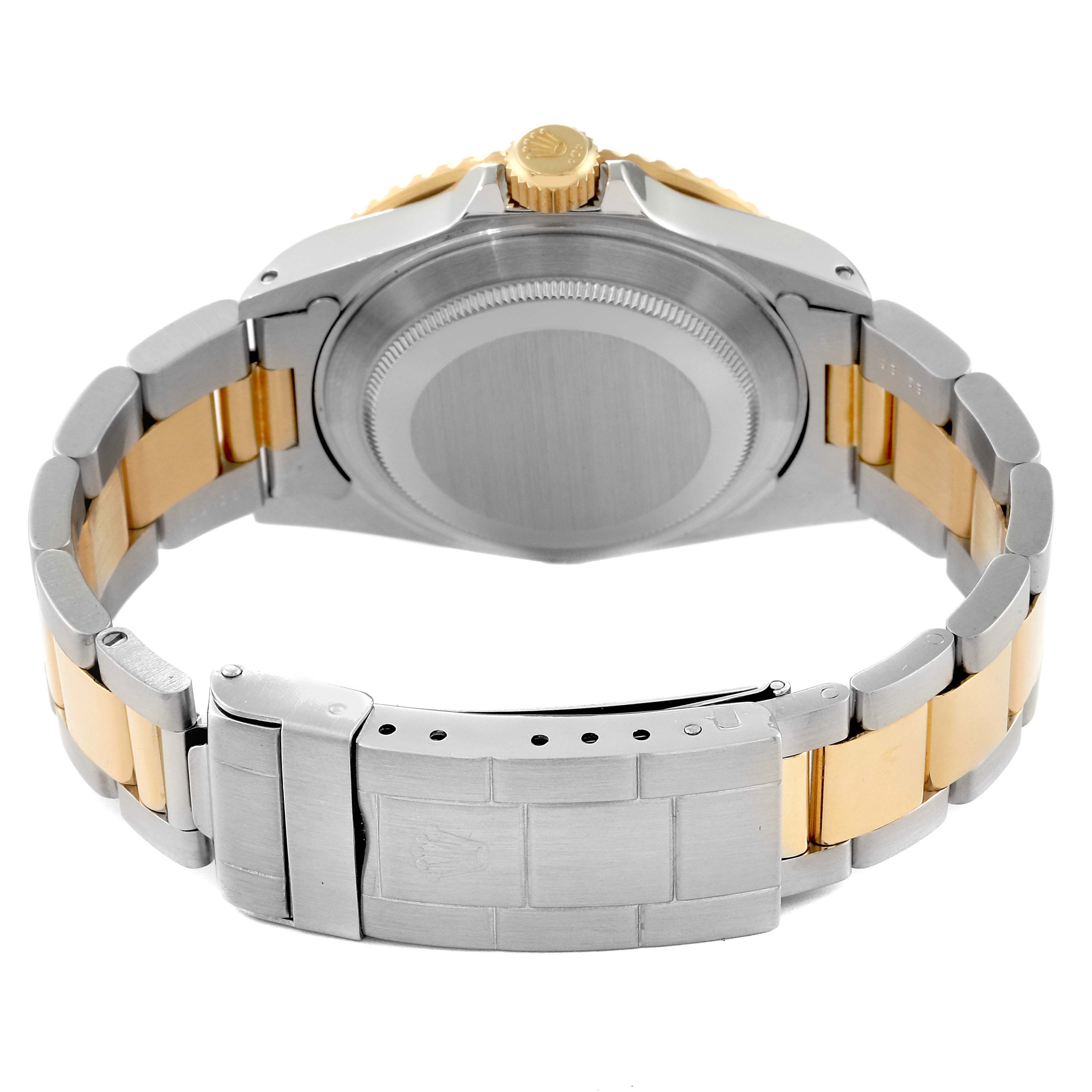 The image shows the back view of a Rolex Submariner 16613 Men's Steel and Gold (two tone) Blue Dial 16613 Men's Steel and Gold (two tone) Blue Dial watch, highlighting its case back, crown, and bracelet with clasp.