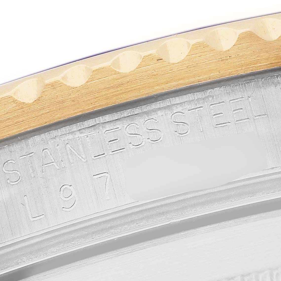 This close-up image shows a side angle of the bezel and case back of a Rolex Submariner 16613 Men's Steel and Gold (two tone) Blue Dial 16613 Men's Steel and Gold (two tone) Blue Dial, highlighting the "STAINLESS STEEL" engraving.