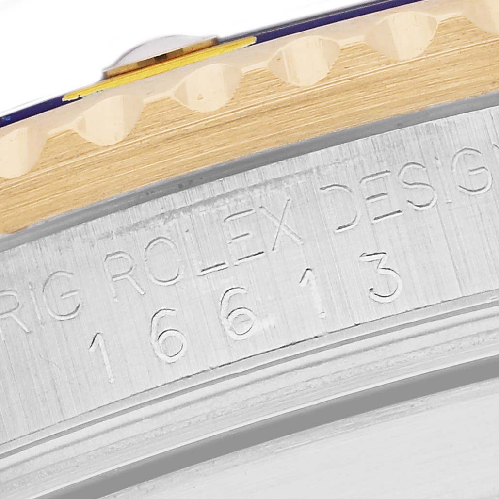 This close-up image shows the engraved side and bezel of a Rolex Submariner 16613 Men's Steel and Gold (two tone) Blue Dial 16613 Men's Steel and Gold (two tone) Blue Dial watch.
