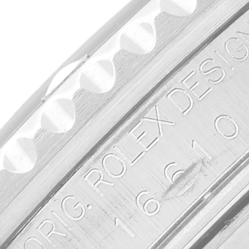 Close-up of the engraved bezel and part of the case of a Rolex Submariner 16610 Men
s Stainless Steel Black Dial 16610 Men
s Stainless Steel Black Dial watch.