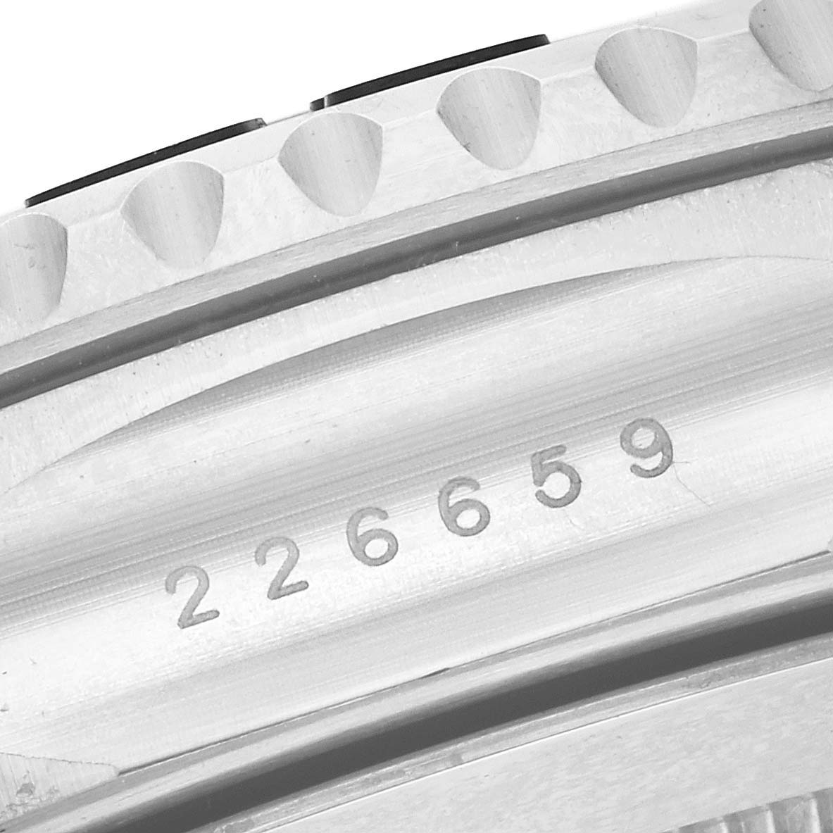 This image shows a close-up angle of the bezel and engraved serial number of the Rolex Yacht-Master 226659 Men's White Gold Black Dial 226659 Men's White Gold Black Dial watch.