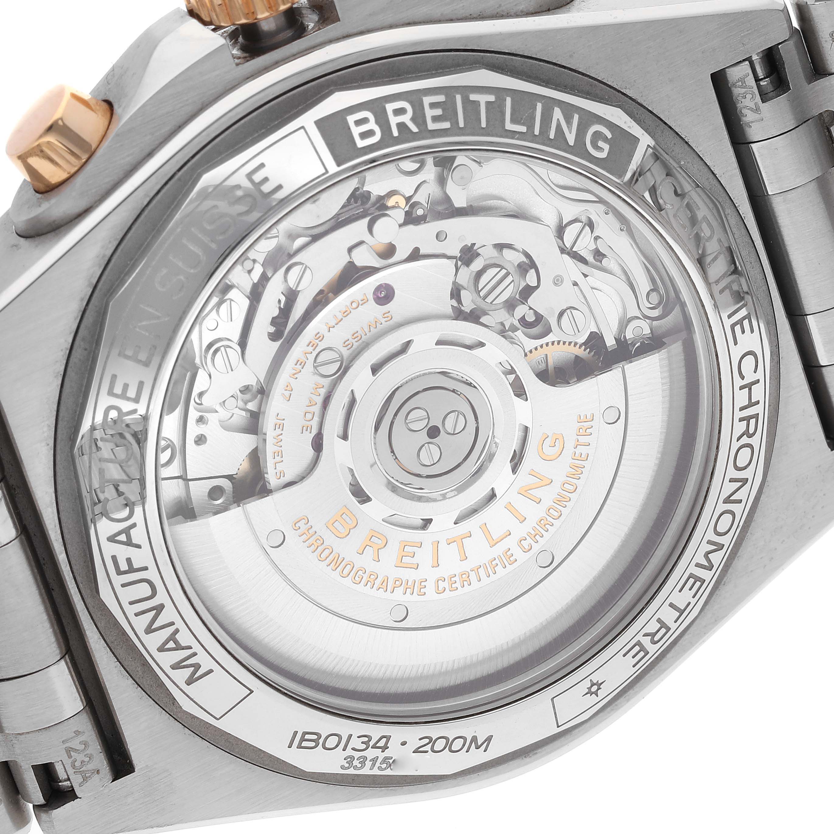 The image shows the back of the Breitling Chronomat IB0134 Men
s Stainless Steel Silver Dial IB0134 Men
s Stainless Steel Silver Dial watch, highlighting its intricate mechanical movement and branding details.