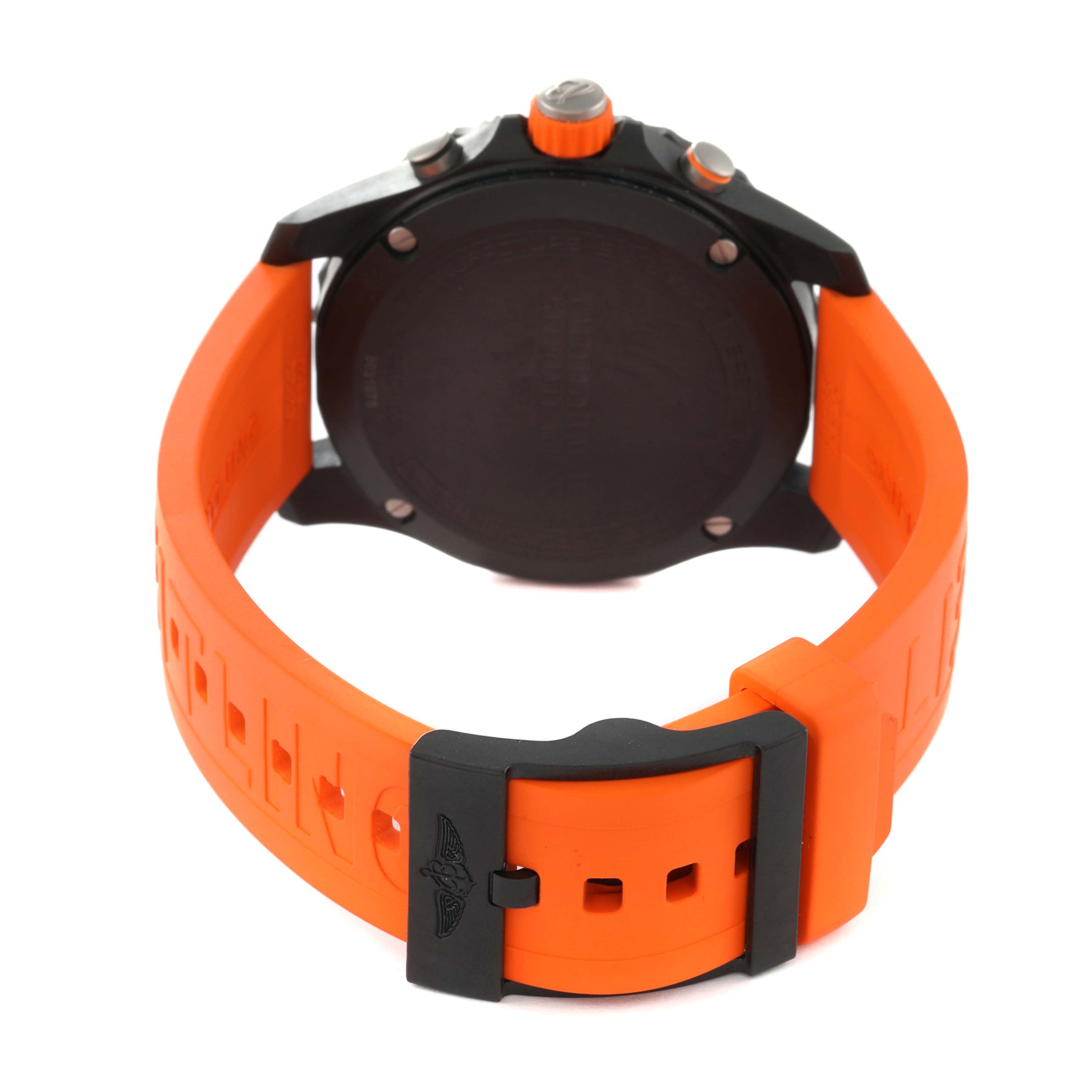 This image shows the backside of a Breitling Professional Series X82310 Men's Ceramic Black Dial X82310 Men's Ceramic Black Dial watch, highlighting its case back, orange strap, and buckle.