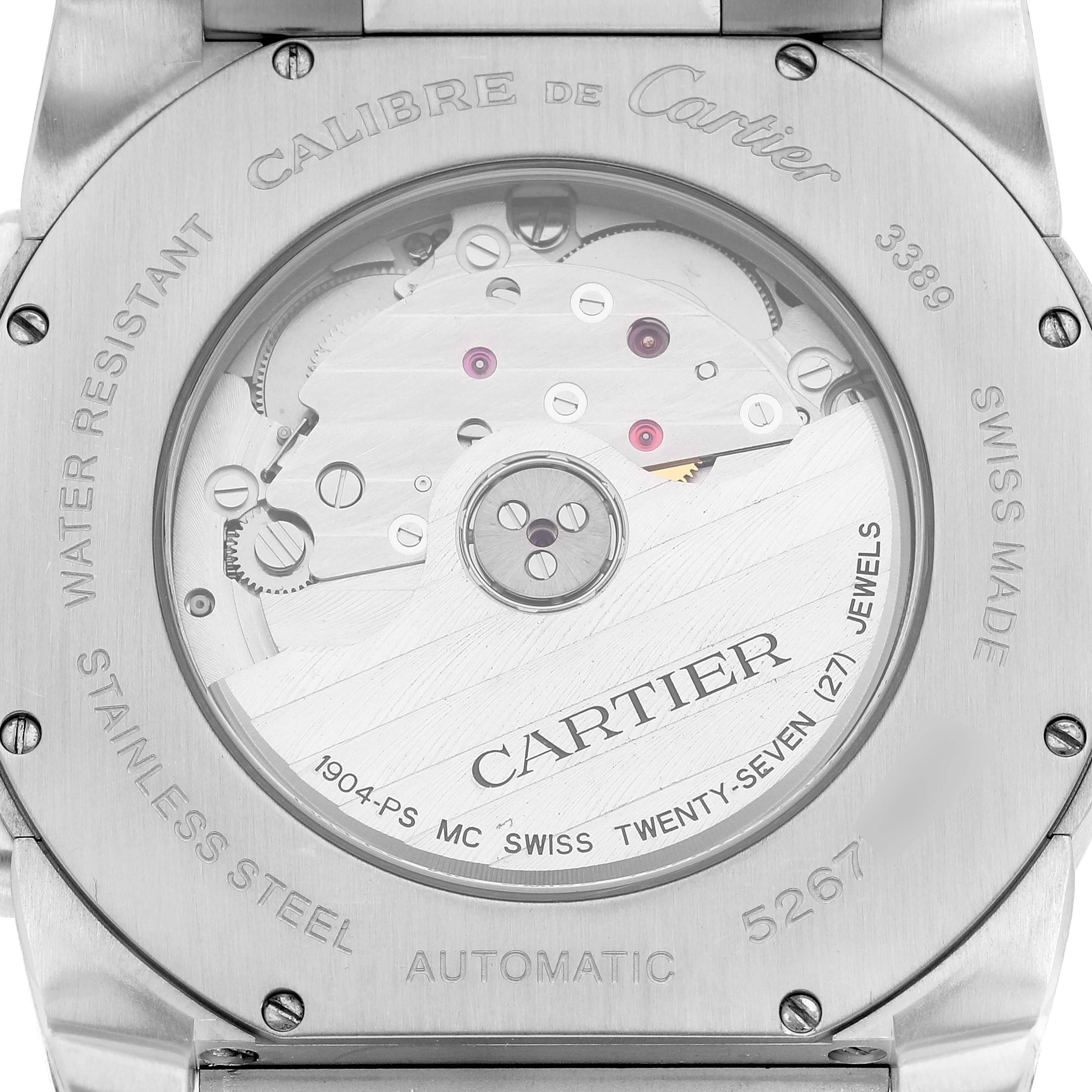 The image shows the back case of the Calibre de Cartier watch by Cartier, displaying its automatic movement and internal mechanisms.