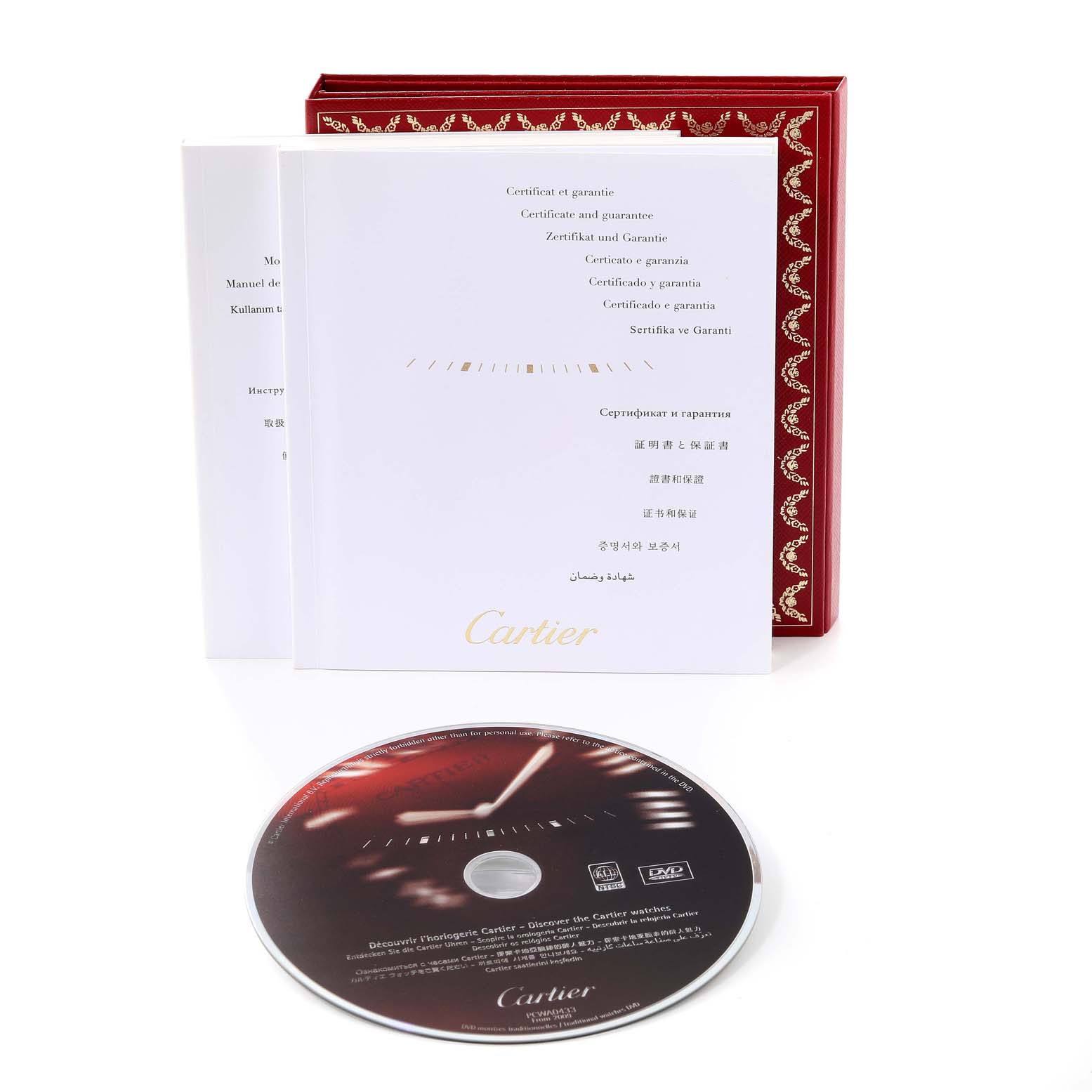 The image shows the warranty booklet, certificate, DVD, and packaging for the Roadster model by Cartier.