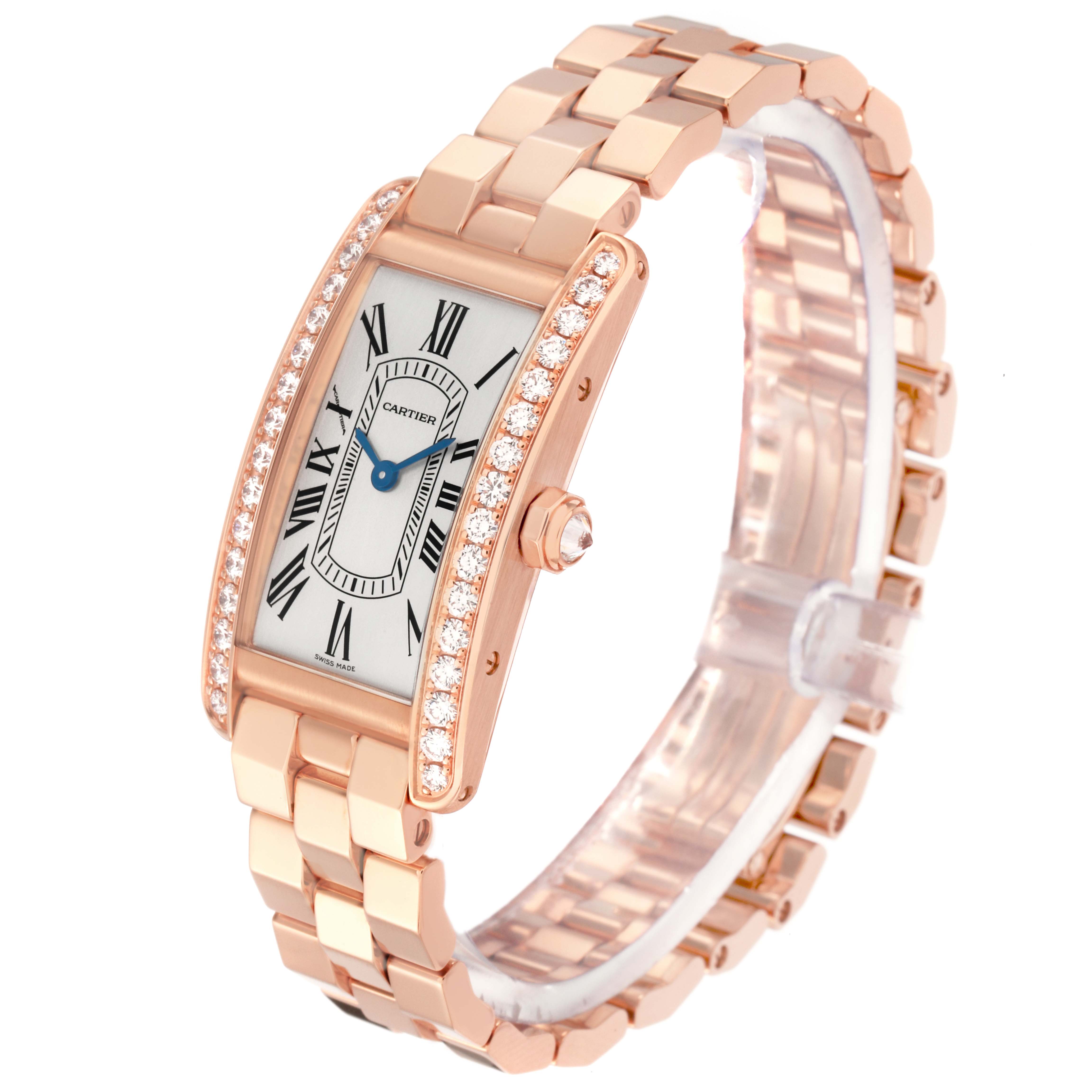 The Cartier Tank Americaine model WJTA0044 watch is shown at a slight top angle, revealing its rectangular face, diamond-accented bezel, and linked bracelet.