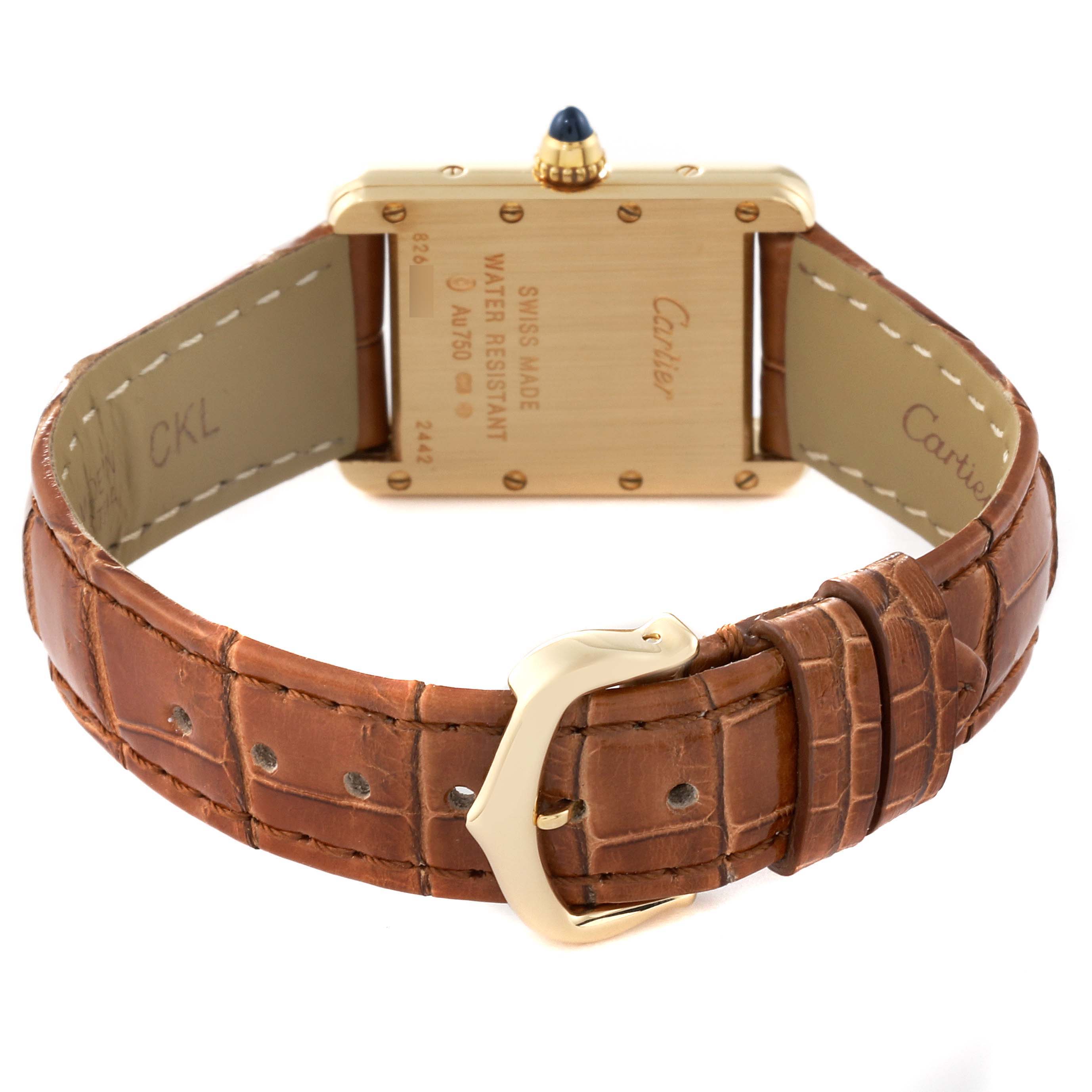 The image shows the back of the Tank Louis Cartier watch, highlighting the case back and brown leather strap with buckle.