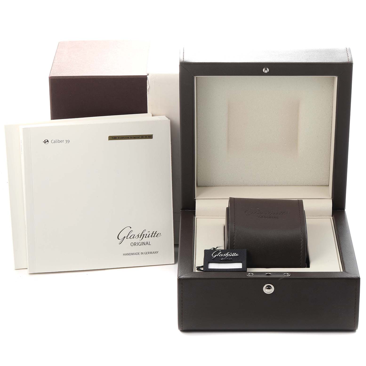 The image shows the packaging and accessories for the Glashütte Senator model, model number 1-39-34-02-32-04, with its box, manual, and tag visible.