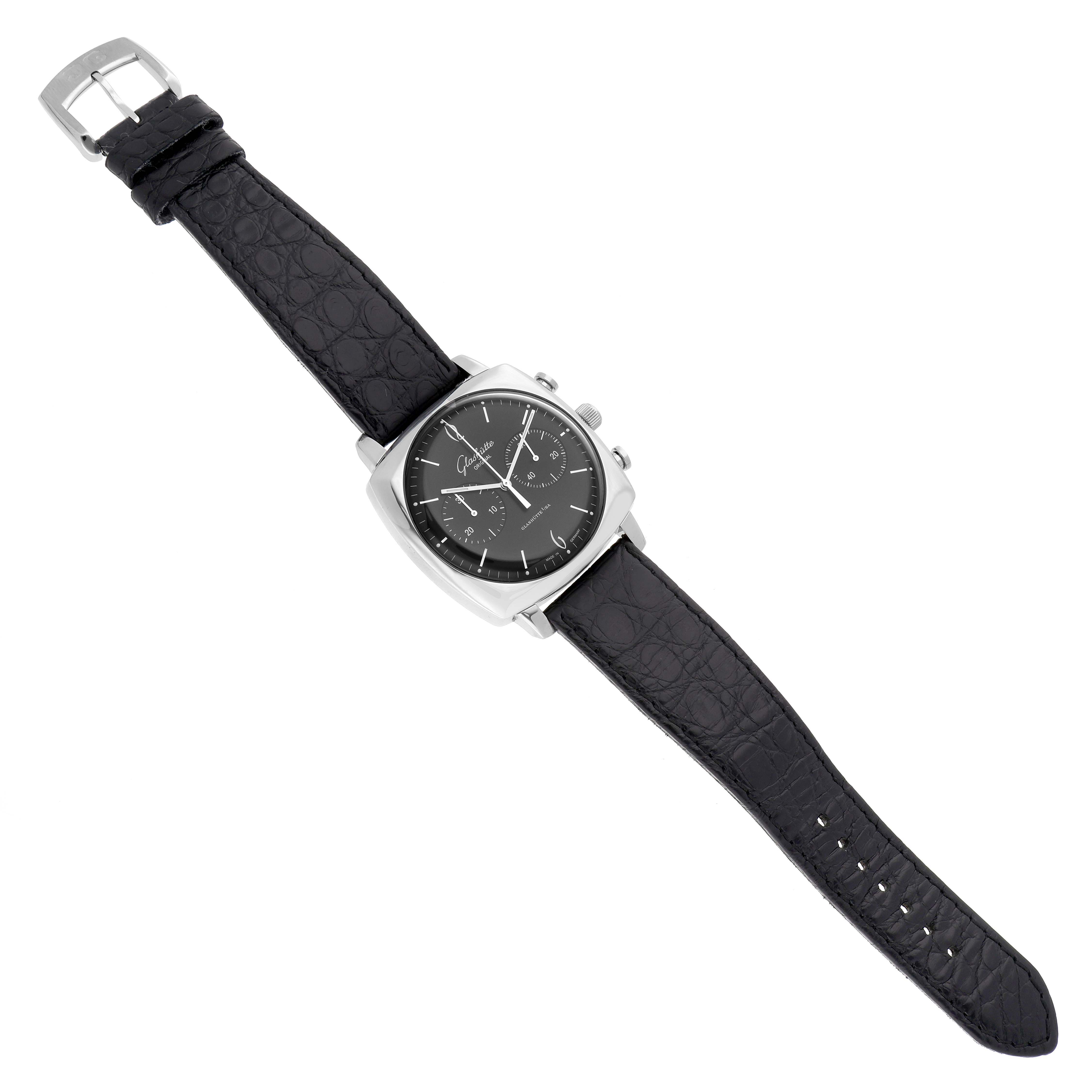 The Glashütte Senator model 1-39-34-02-32-04 watch is shown from a top view, displaying its black dial, silver case, and leather strap.