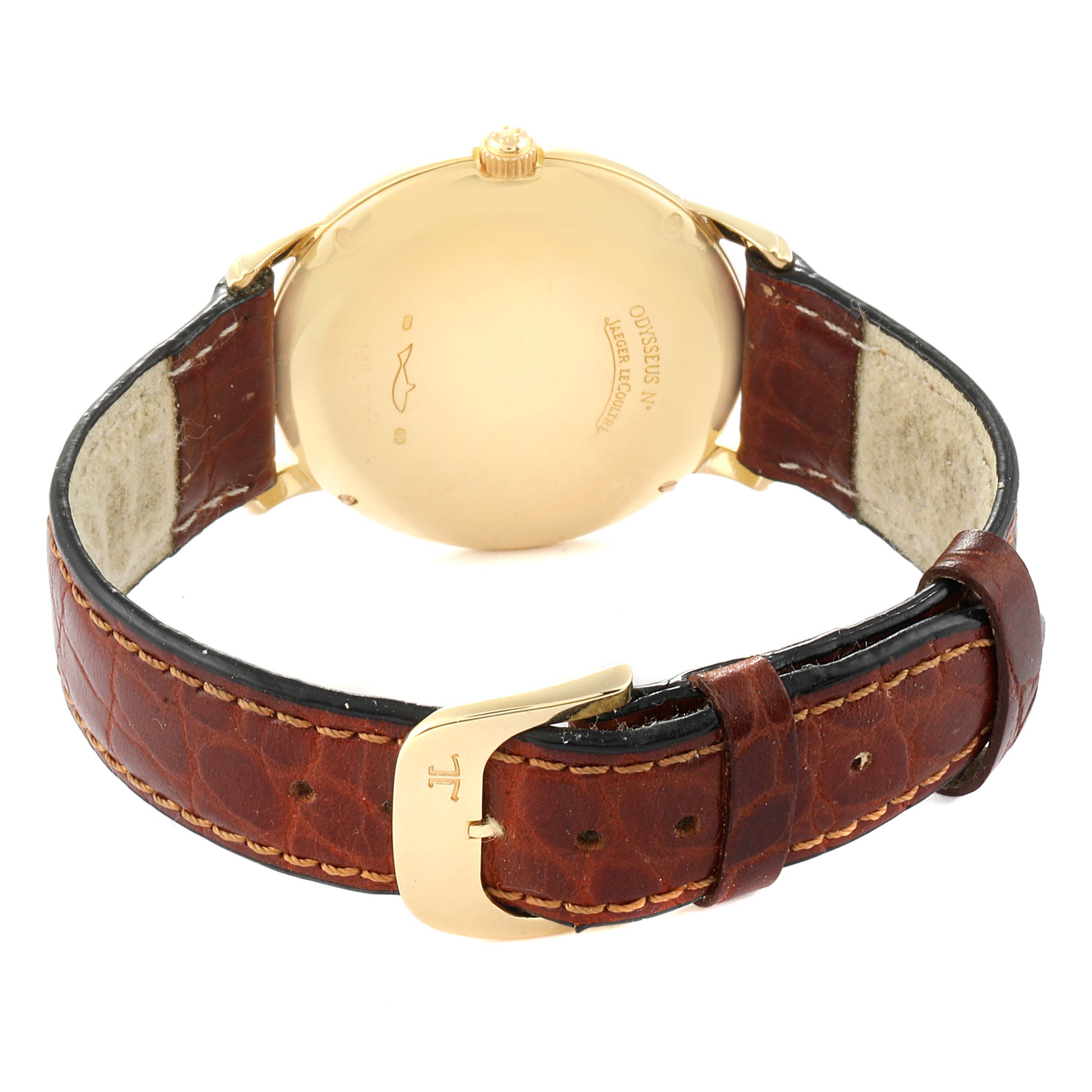 The image shows the back view of a Vintage Jaeger LeCoultre watch, highlighting its gold case back and leather strap with a buckle.