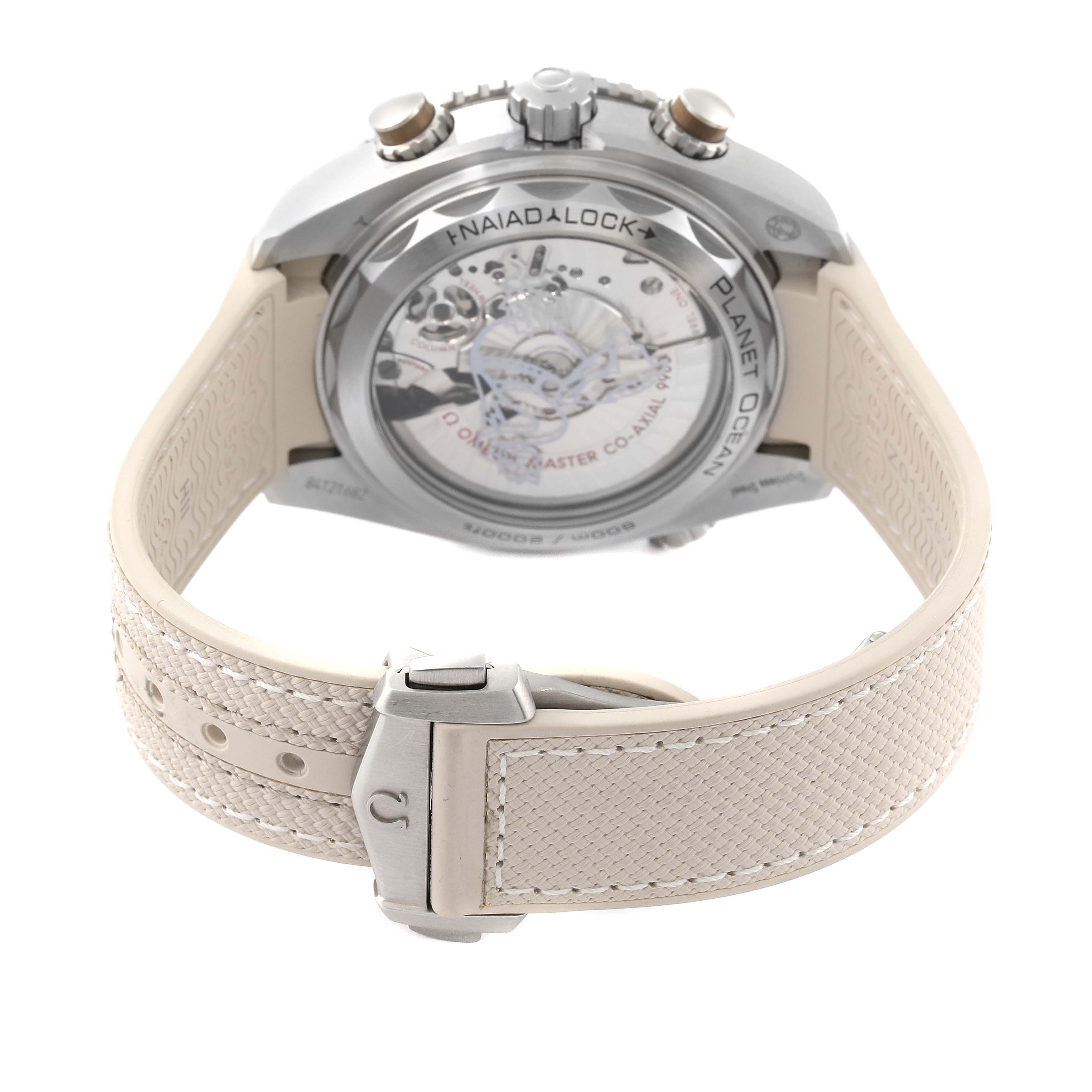 The image shows the back and strap of the Omega Planet Ocean 215.32.46.51.09.001 Men's Stainless Steel Beige Dial 215.32.46.51.09.001 Men's Stainless Steel Beige Dial watch, highlighting the Naiad lock system and visible movement.