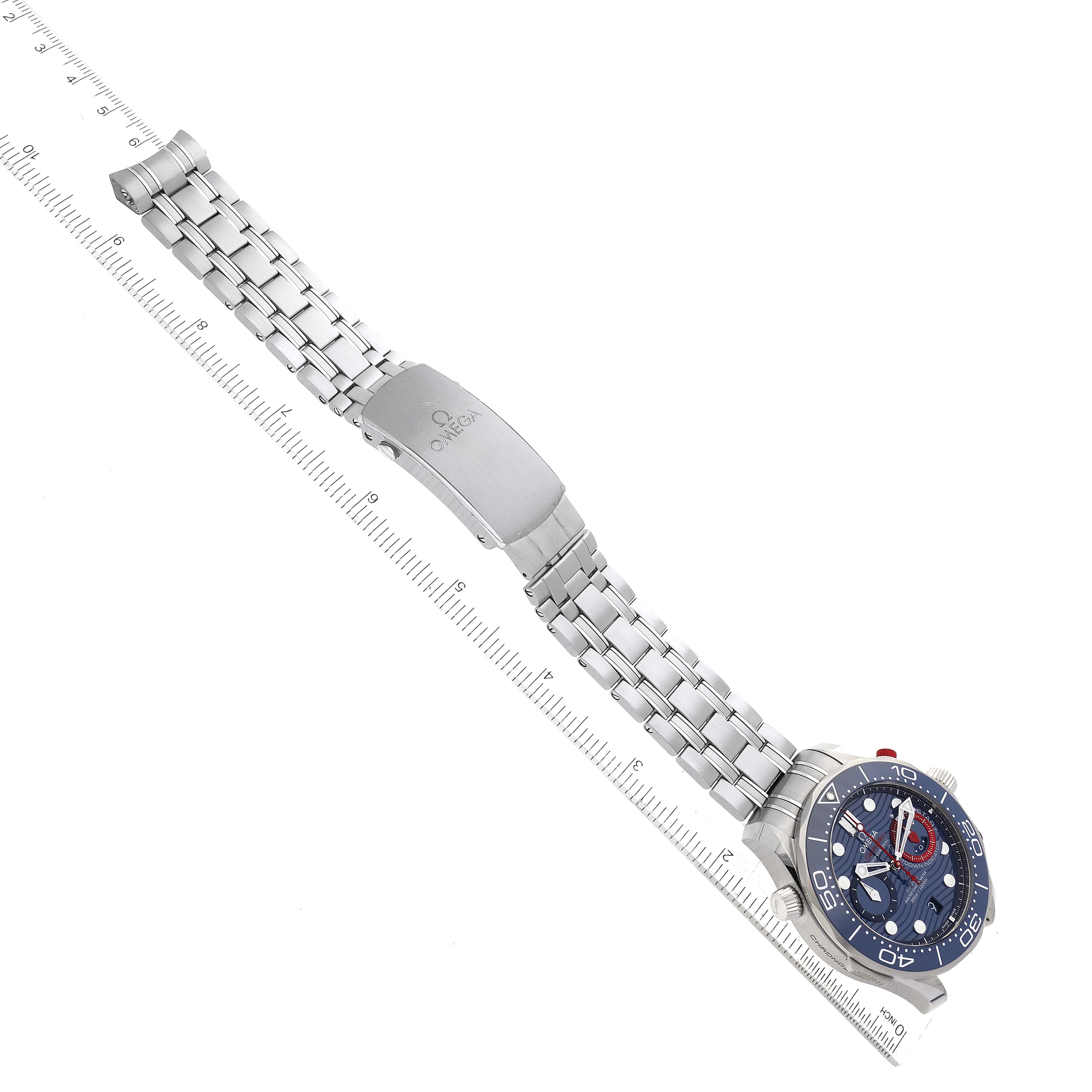 The Omega Seamaster 63377 Men
s Stainless Steel Blue Dial 63377 Men
s Stainless Steel Blue Dial watch is shown lying flat, displaying its metal bracelet, clasp, and blue dial face.