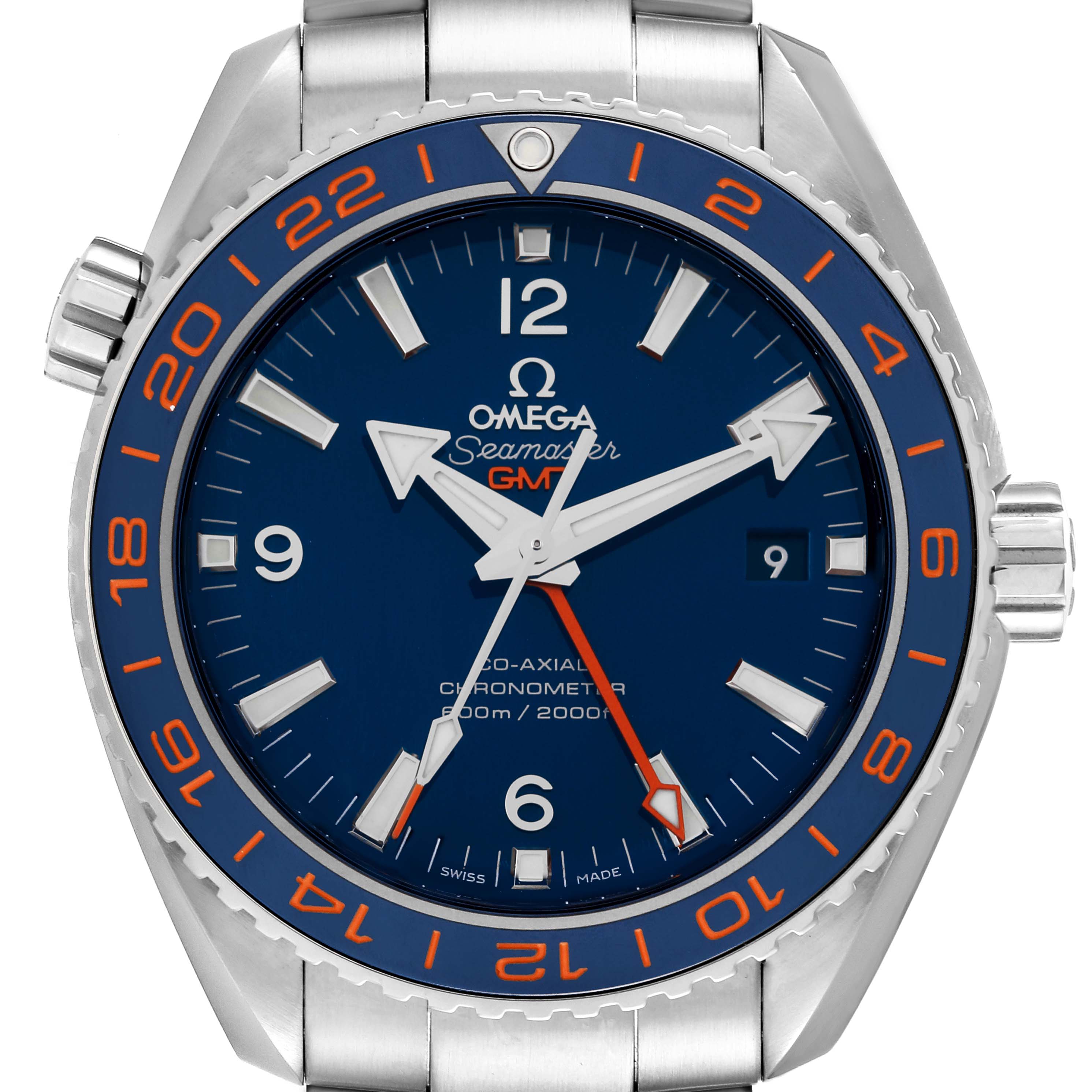 The image shows a front view of an Omega Planet Ocean 232.30.44.22.03.001 Men's Stainless Steel Blue Dial 232.30.44.22.03.001 Men's Stainless Steel Blue Dial watch, highlighting its blue dial, orange GMT hand, and date window at 3 o'clock.