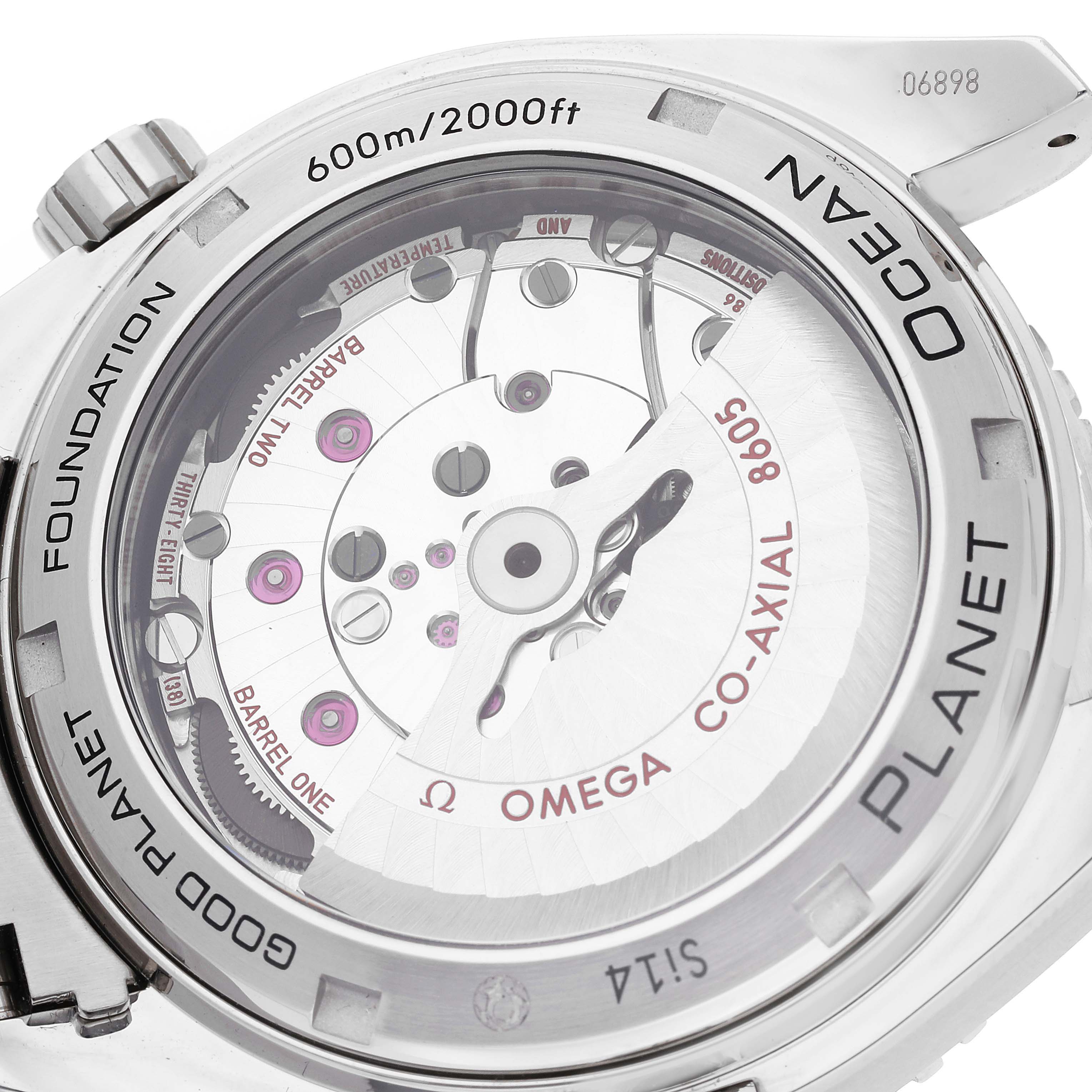 The image shows the back of the Omega Planet Ocean 232.30.44.22.03.001 Men's Stainless Steel Blue Dial 232.30.44.22.03.001 Men's Stainless Steel Blue Dial watch, highlighting its transparent case, co-axial movement, and intricate gears.