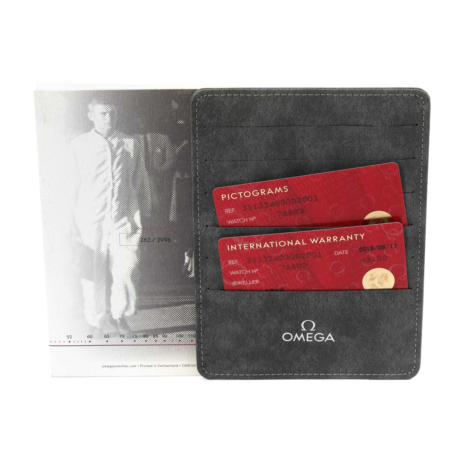 The image shows an Omega Speedmaster 311.32.40.30.02.001 Men
s Stainless Steel Silver Dial 311.32.40.30.02.001 Men
s Stainless Steel Silver Dial
s pictograms and international warranty cards in a gray Omega-branded cardholder.