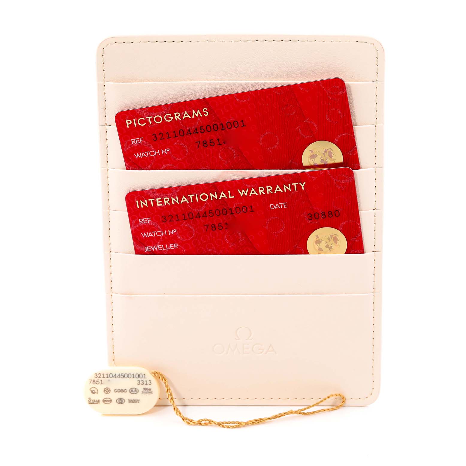 The image shows warranty and pictograms cards for the Omega Speedmaster 321.10.44.50.01.001 Men's Stainless Steel Black Dial 321.10.44.50.01.001 Men's Stainless Steel Black Dial watch, along with a tag, in a cream cardholder.