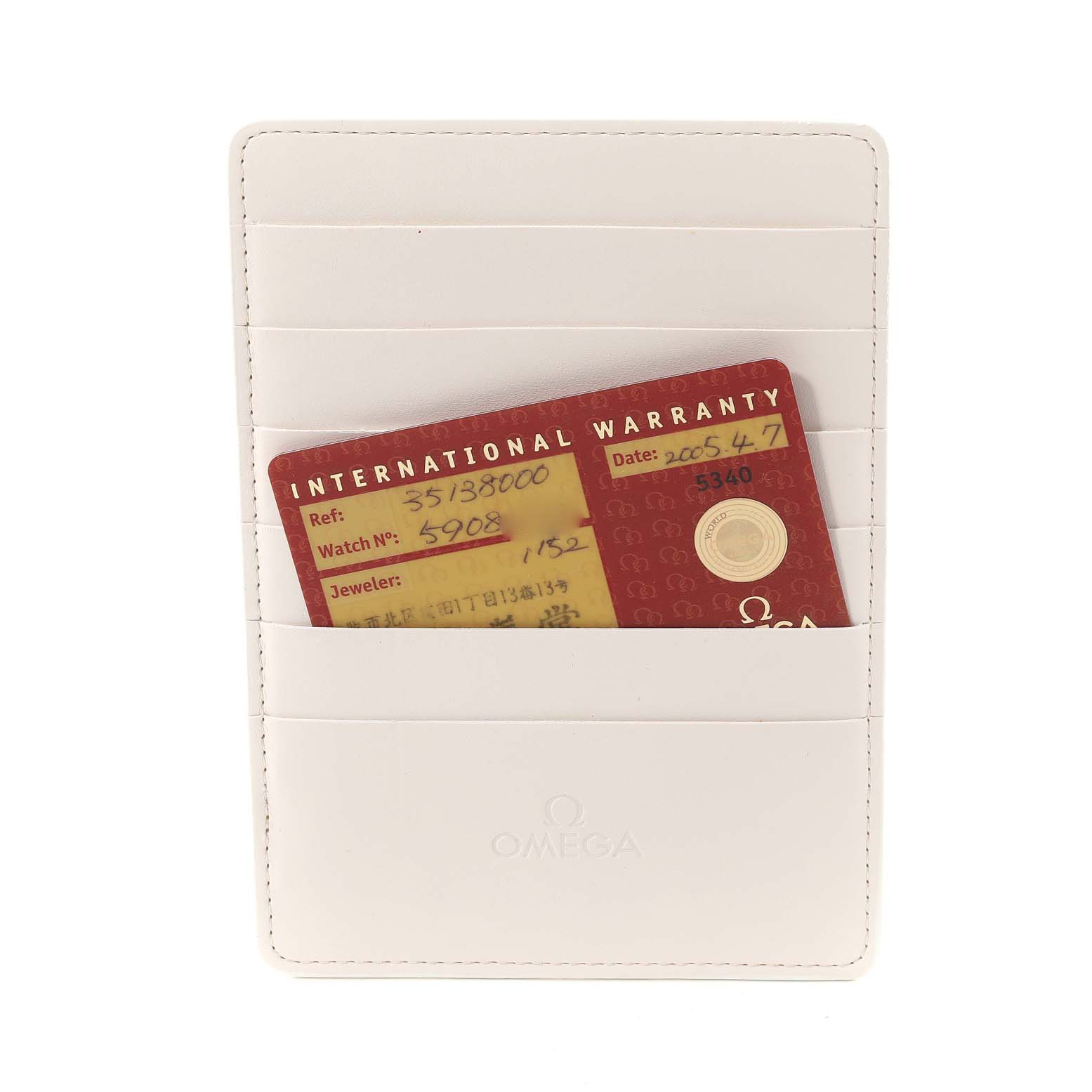 The image shows an Omega Speedmaster 3513.80.00 Men
s Stainless Steel Blue Dial 3513.80.00 Men
s Stainless Steel Blue Dial warranty card inside a white cardholder, viewed from the front.