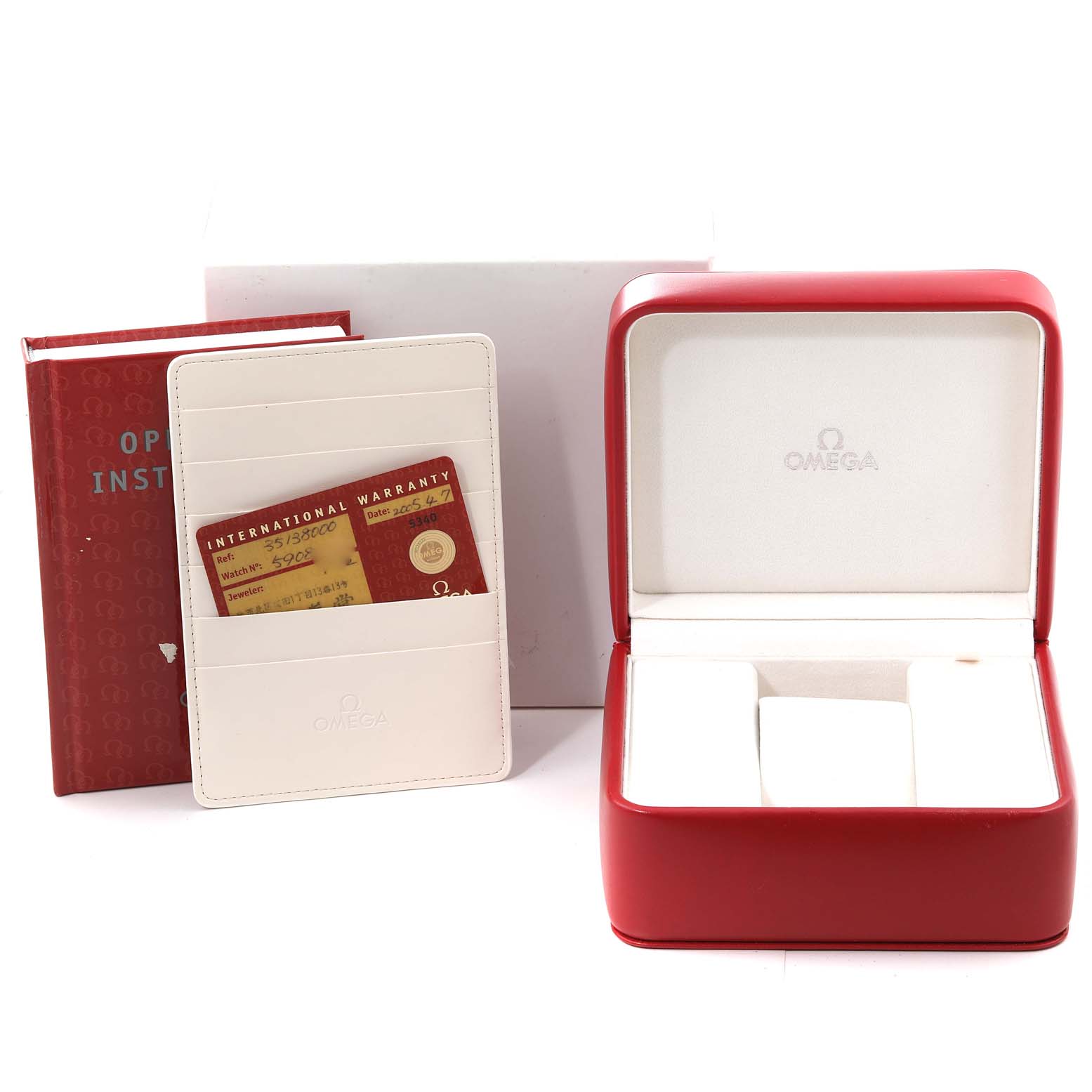 The image shows an Omega Speedmaster 3513.80.00 Men
s Stainless Steel Blue Dial 3513.80.00 Men
s Stainless Steel Blue Dial accessories kit including the watch box, instruction manual, and an international warranty card holder.