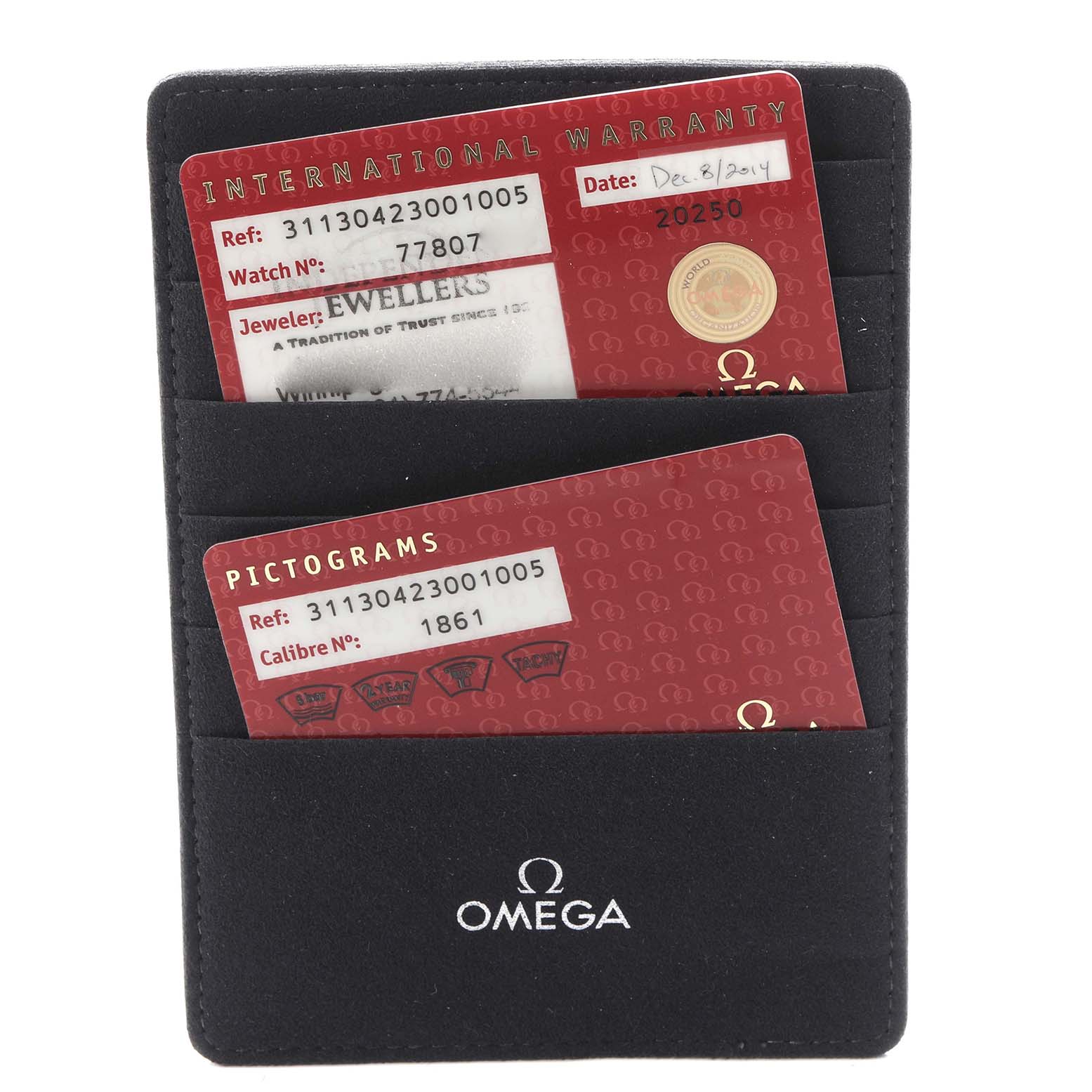 The image shows International Warranty and Pictograms cards for an Omega Speedmaster model 311.30.42.30.01.005, held in a black Omega cardholder.