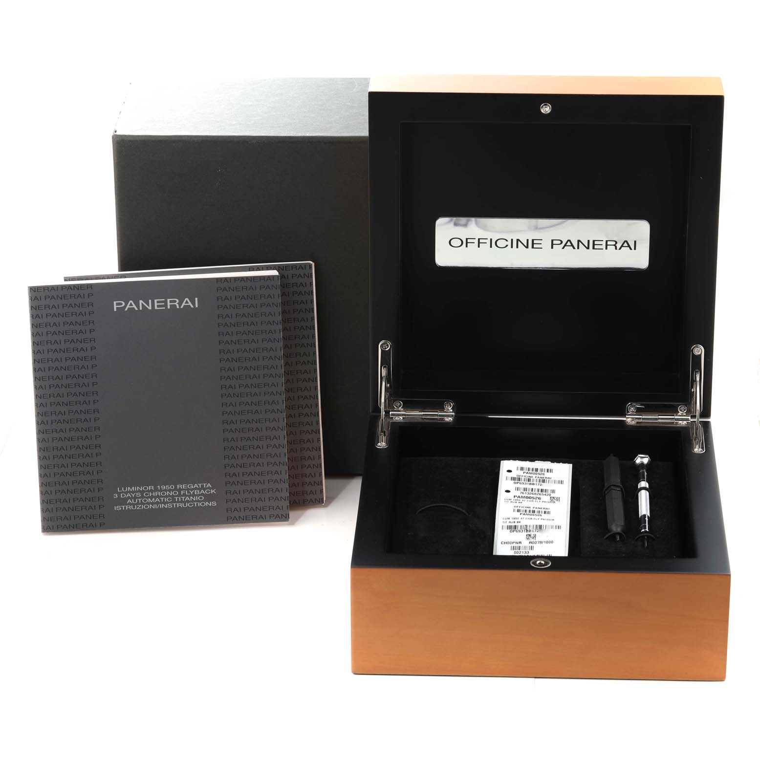 The image shows the open box and accessories of a Panerai Luminor PAM00526 Men's Titanium Black Dial PAM00526 Men's Titanium Black Dial watch, including manuals and tools.