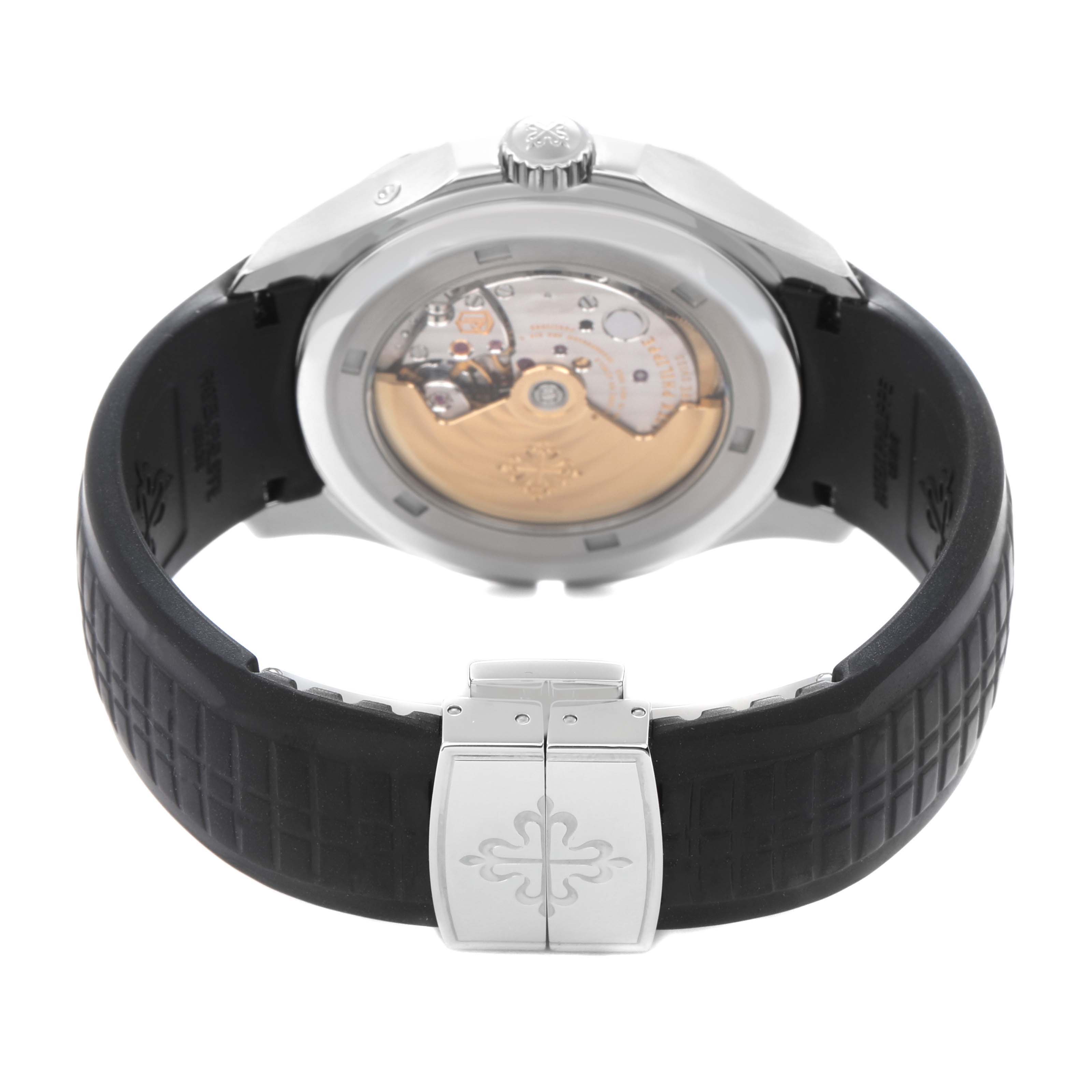 The Patek Philippe Aquanaut 5164A-001 watch is shown from the rear, displaying its open case back and part of the rubber strap with a clasp.