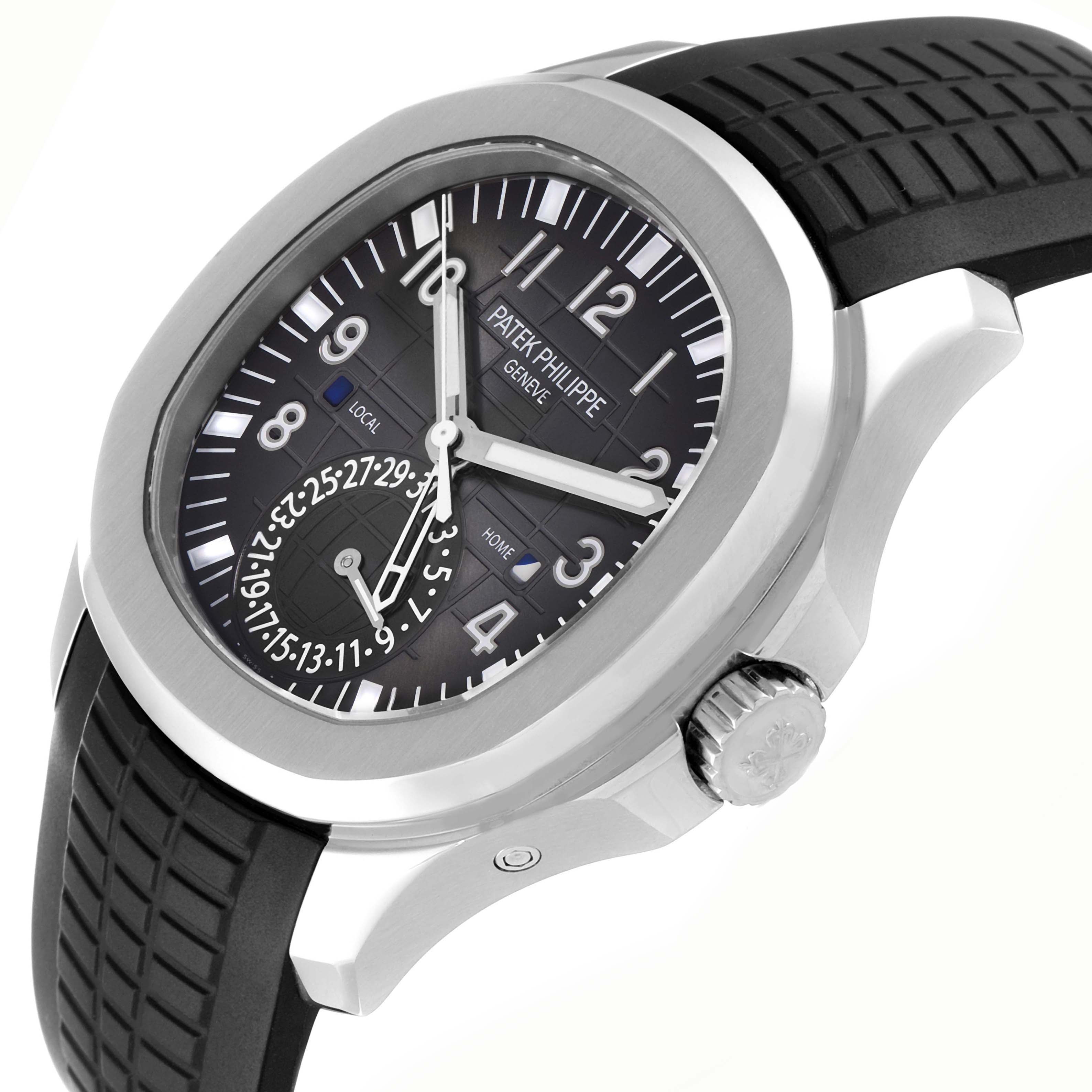 The image shows a Patek Philippe Aquanaut 5164A-001 men
s watch from a side angle, highlighting the face, bezel, crown, and black textured strap.