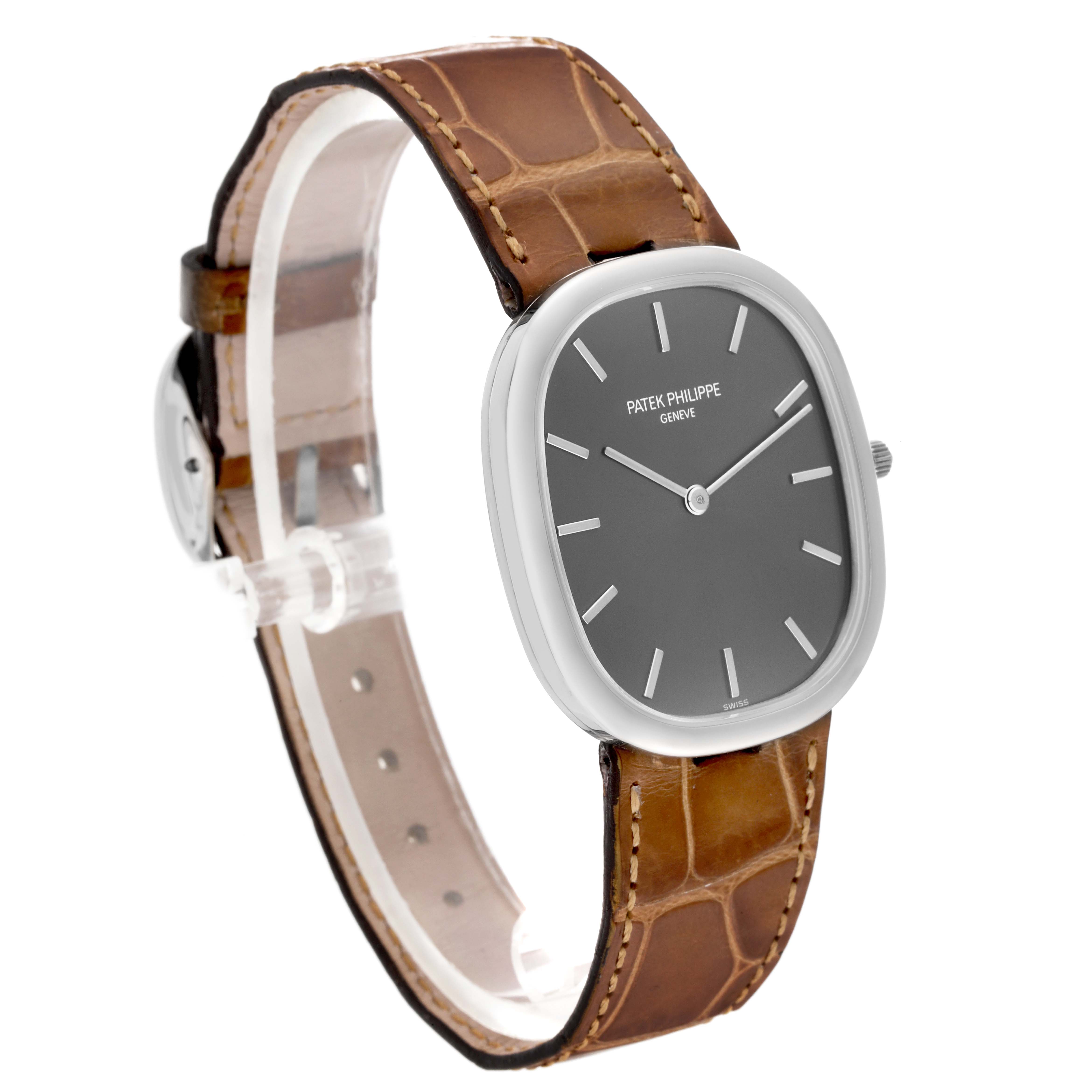 The Patek Philippe Golden Ellipse 3738/100G-012 Men's White Gold Grey Dial 3738/100G-012 Men's White Gold Grey Dial watch is shown at a 3/4 angle, highlighting its face, side profile, and brown leather strap.