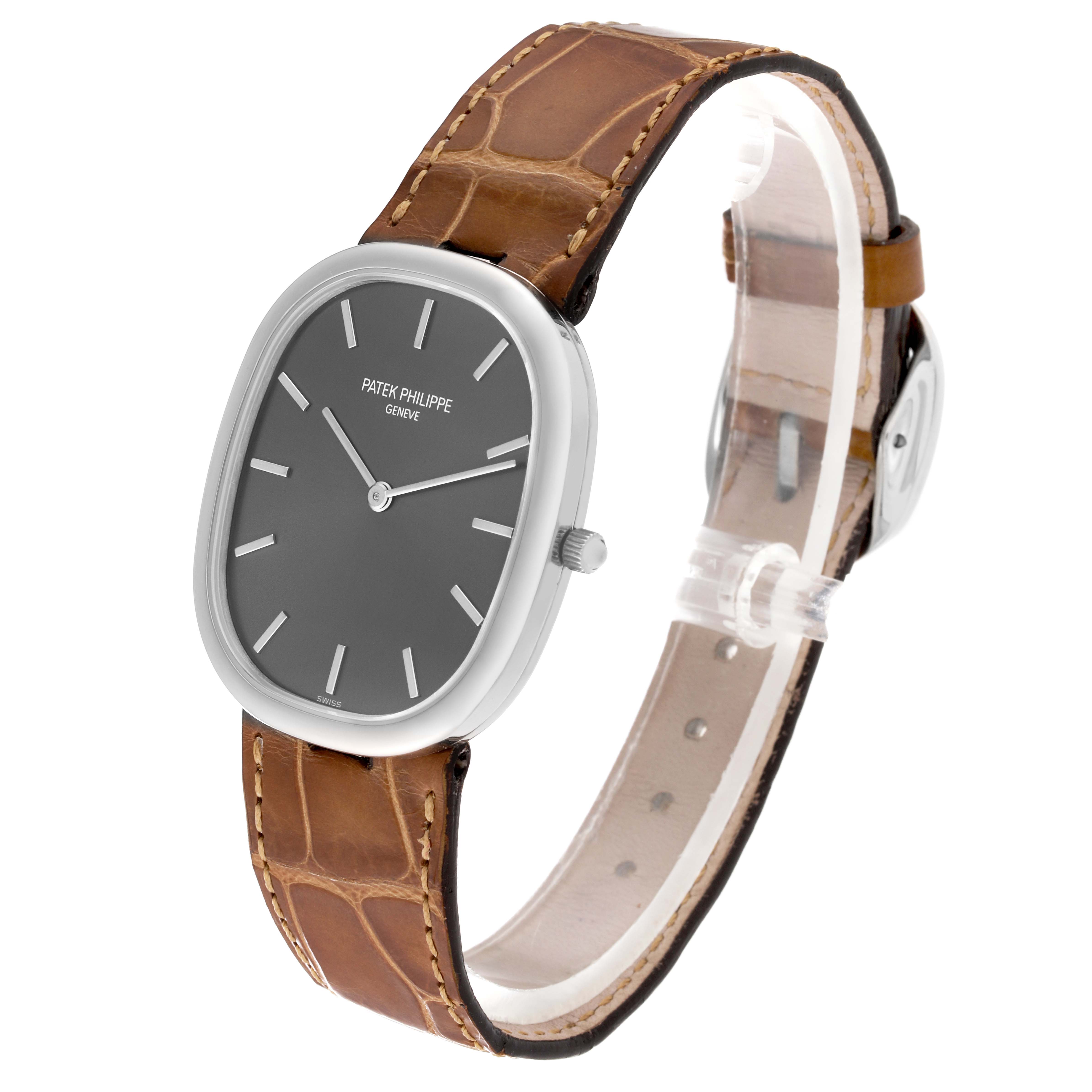 The image shows a side view of the Patek Philippe Golden Ellipse 3738/100G-012 Men's White Gold Grey Dial 3738/100G-012 Men's White Gold Grey Dial watch, highlighting its dial, case, and brown leather strap.